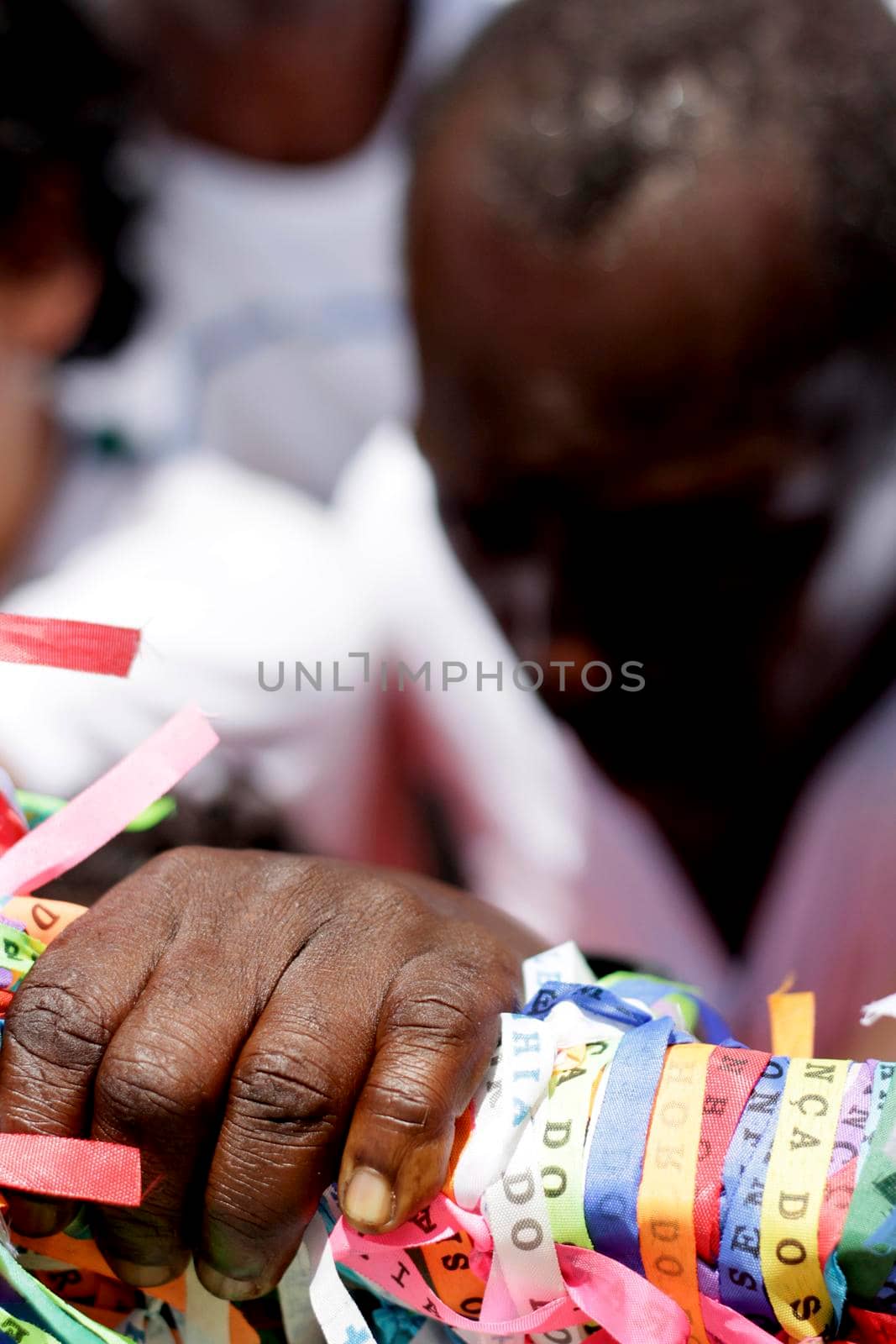 salvador, bahia / brazil - january 15, 2015: person is seen holding tapes of Senhor do Bonfim during religious procession in the church in the city of Salvador.