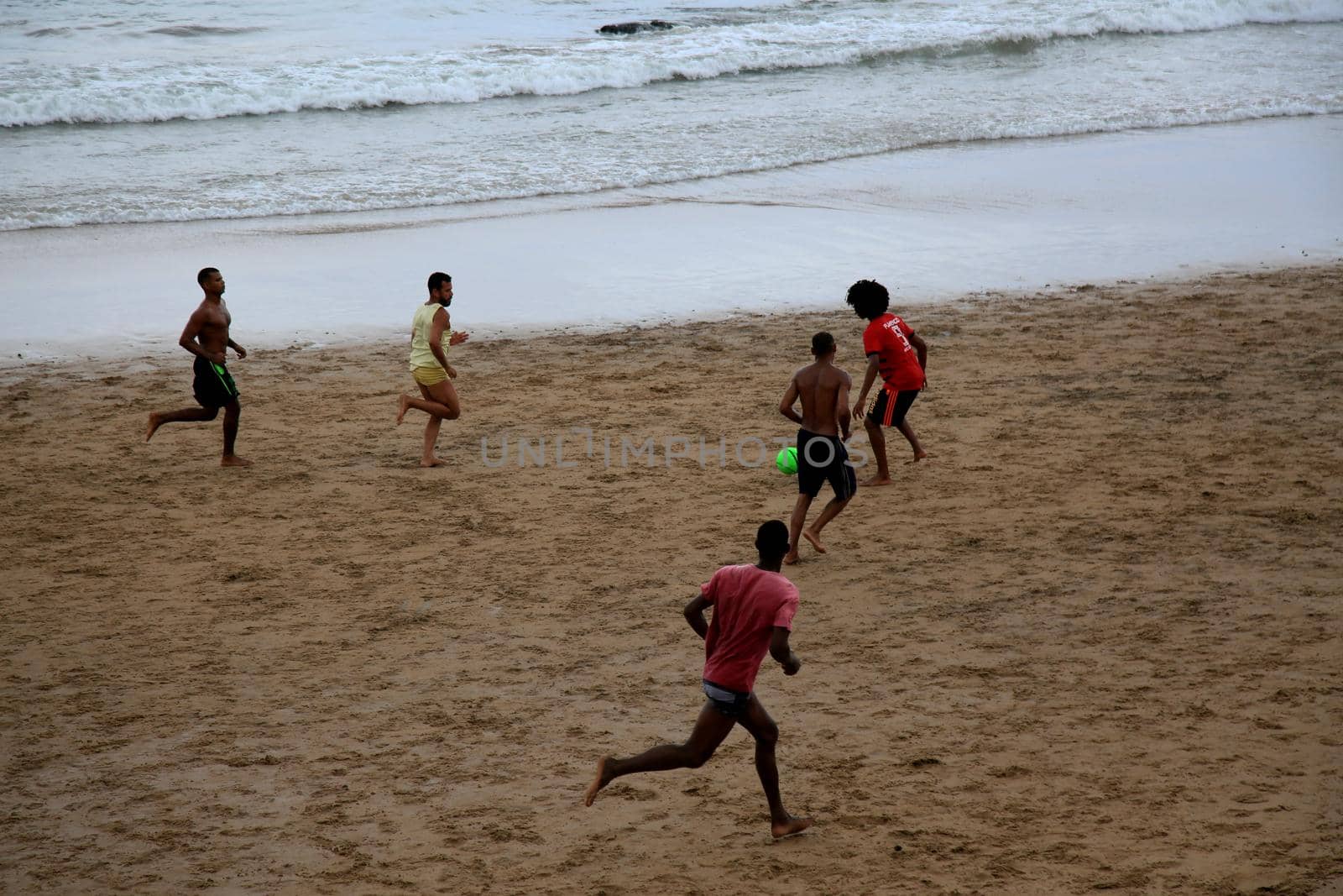 salvador, bahia, brazil - january 15, 2021: people are seen playing football on Ondina beach in the city of Salvador.