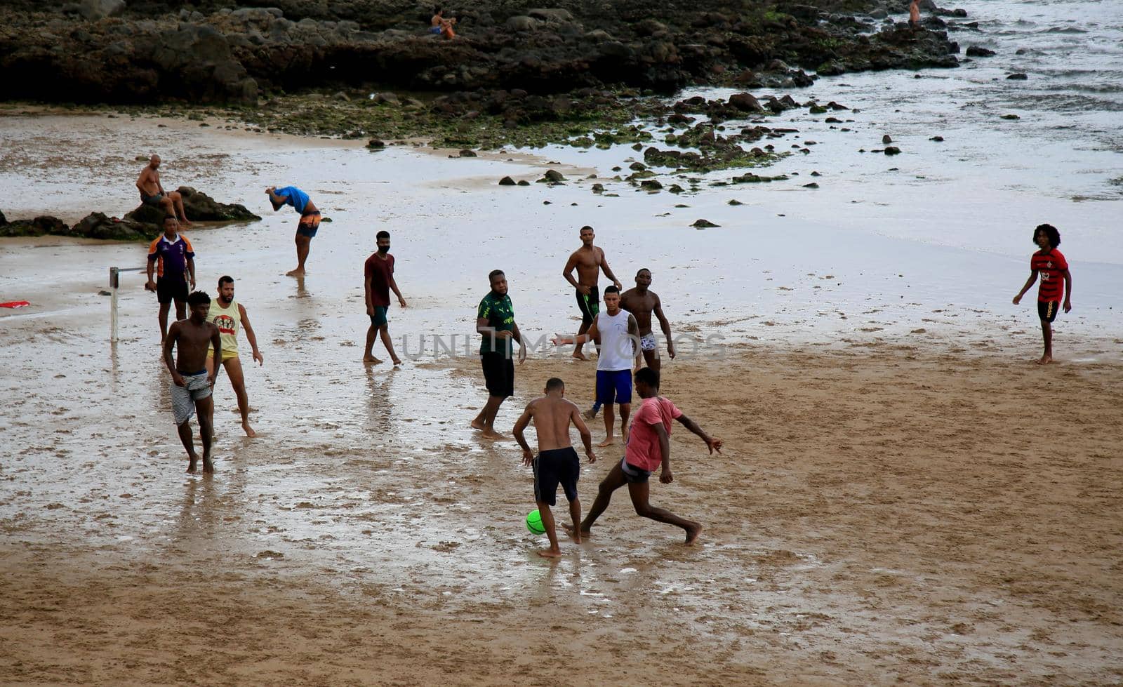 salvador, bahia, brazil - january 15, 2021: people are seen playing football on Ondina beach in the city of Salvador.