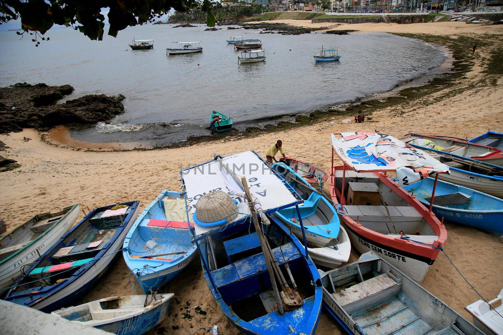 salvador, bahia, brazil - january 15, 2021: fishing boats are seen collected in the sand of Paciencia beach, in the Rio Vermelho neighborhood, in the city of Salvador, due to rainy weather.
