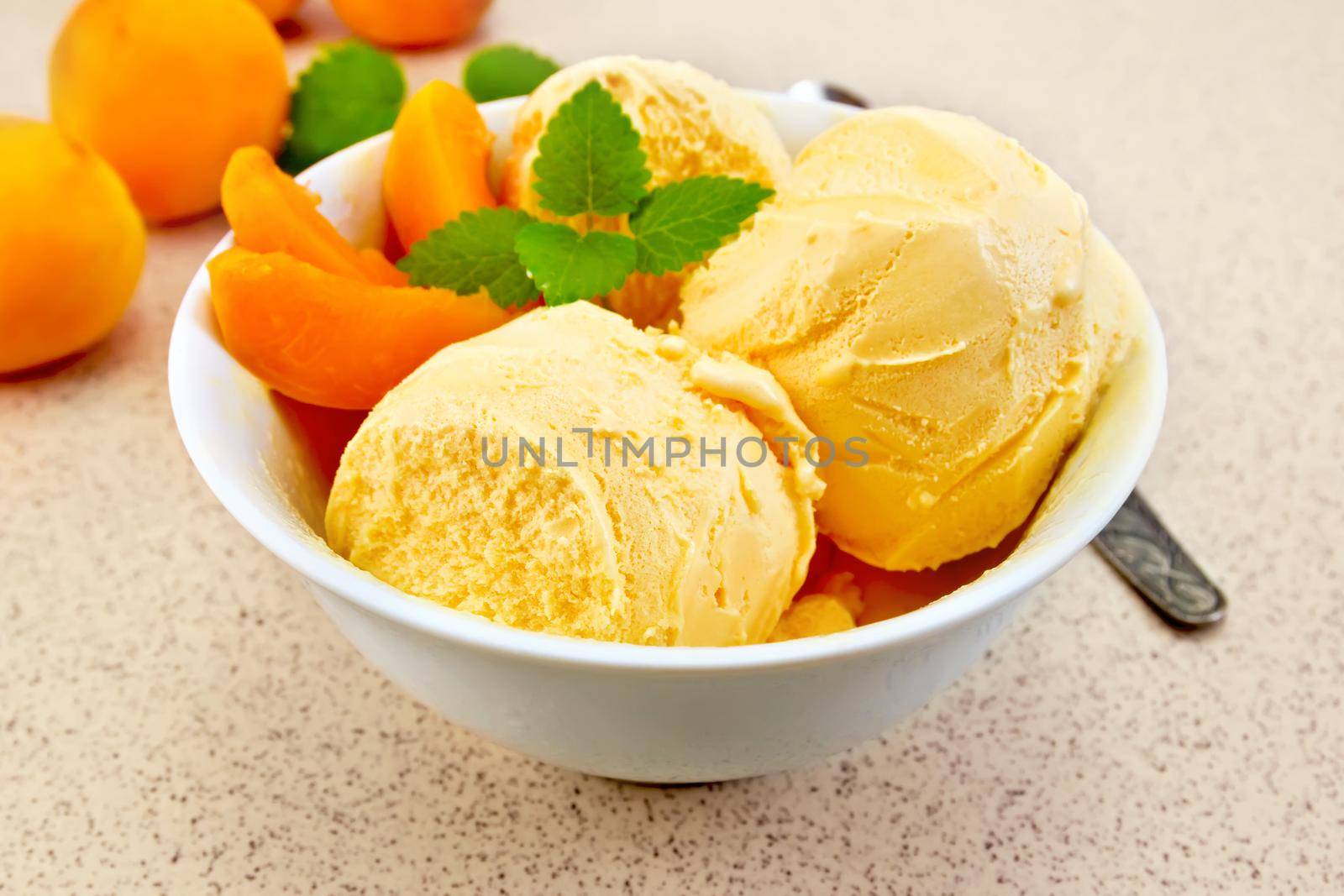 Ice cream apricot in white bowl on table by rezkrr