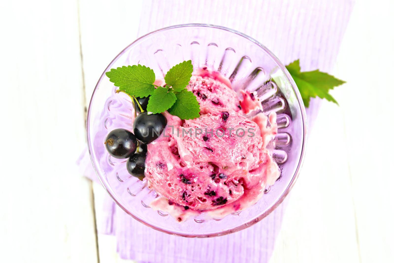 Ice cream with black currant on board top by rezkrr