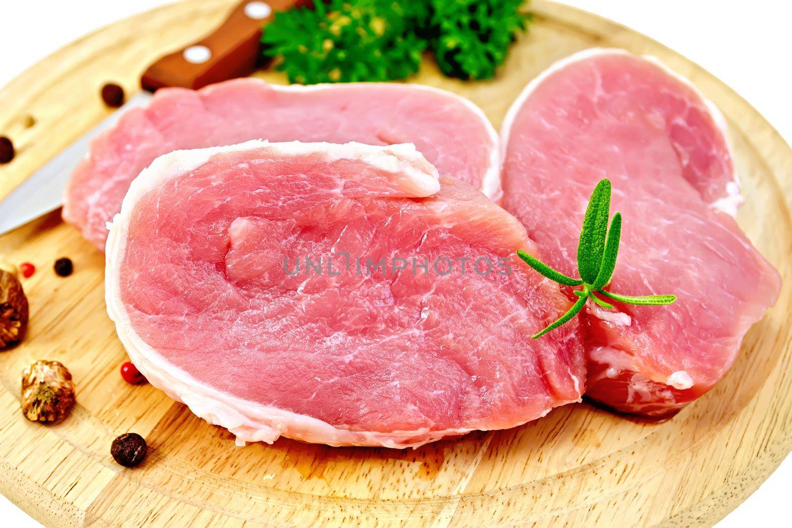 Meat pork slices with rosemary on round board by rezkrr
