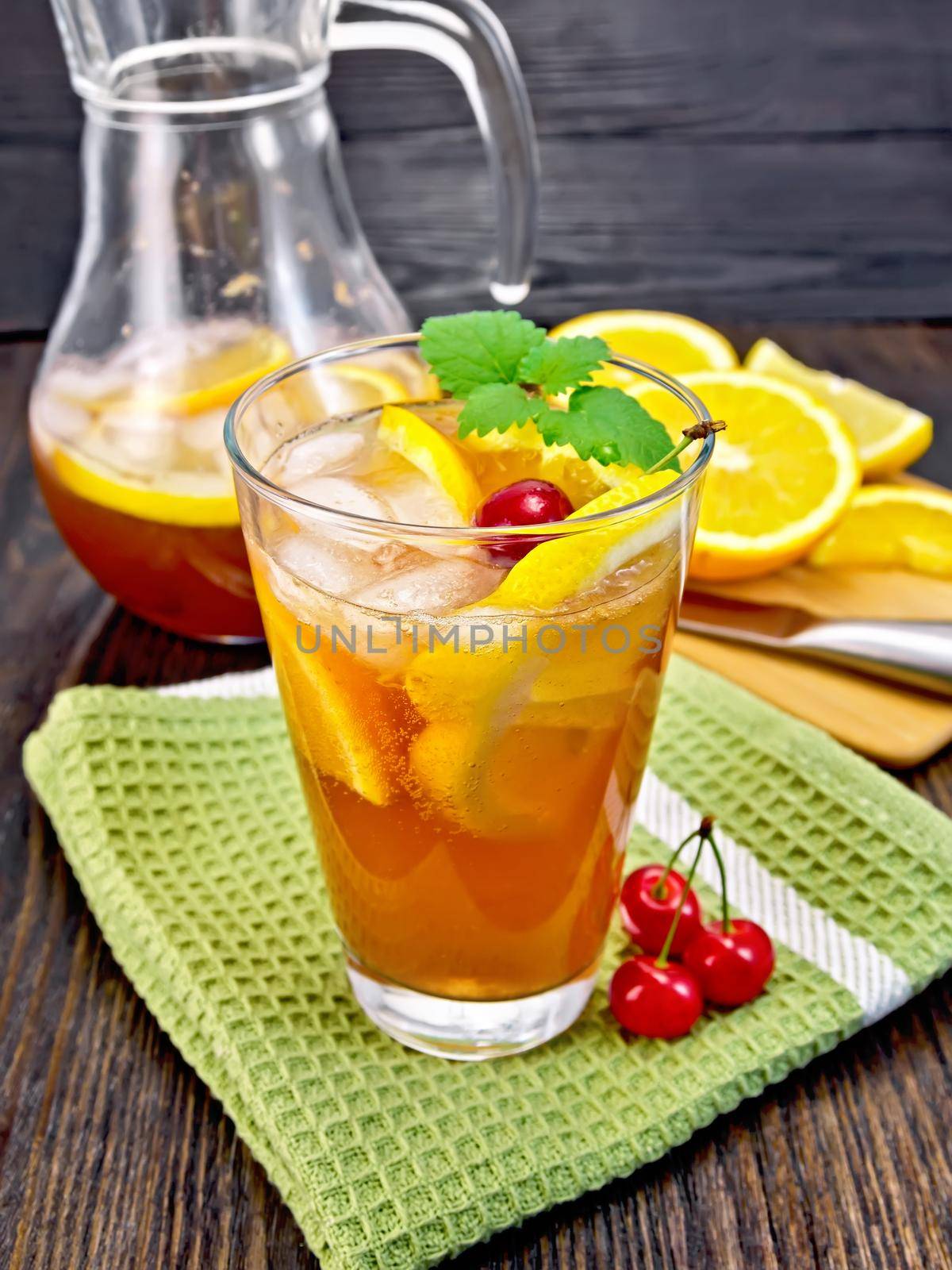Lemonade with cherries in glassful and jug on board by rezkrr
