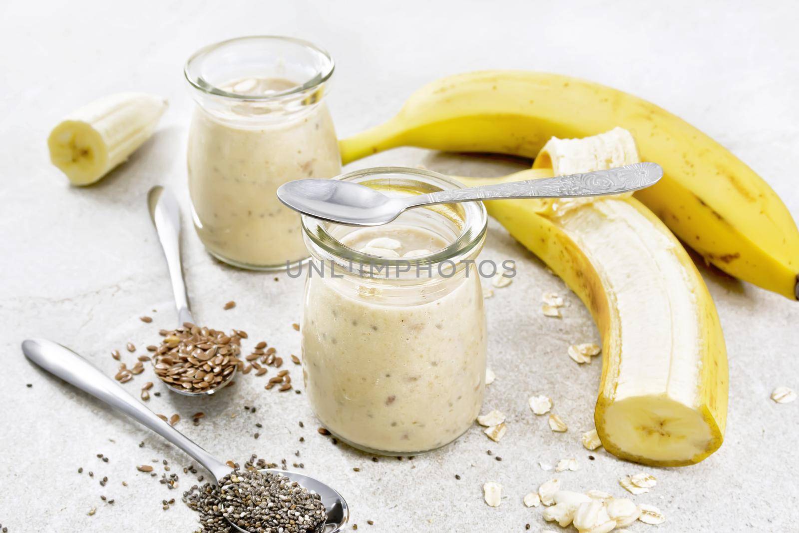 Milkshake with chia and banana in jars on granite table by rezkrr