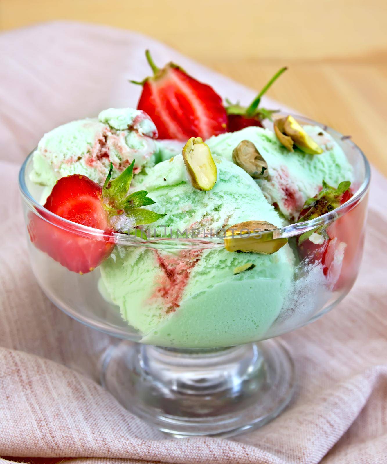 Ice cream strawberry-pistachio on napkin and board by rezkrr