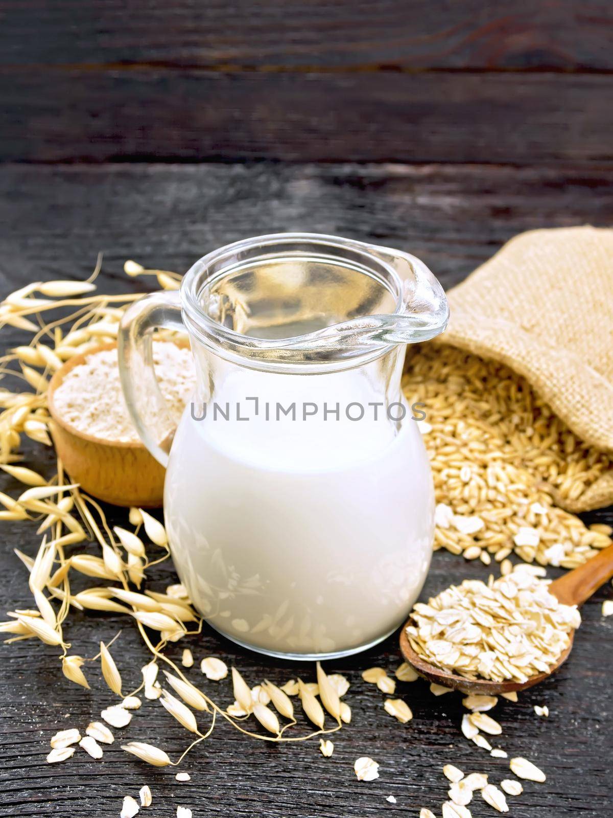 Milk oatmeal in jug on wooden board by rezkrr