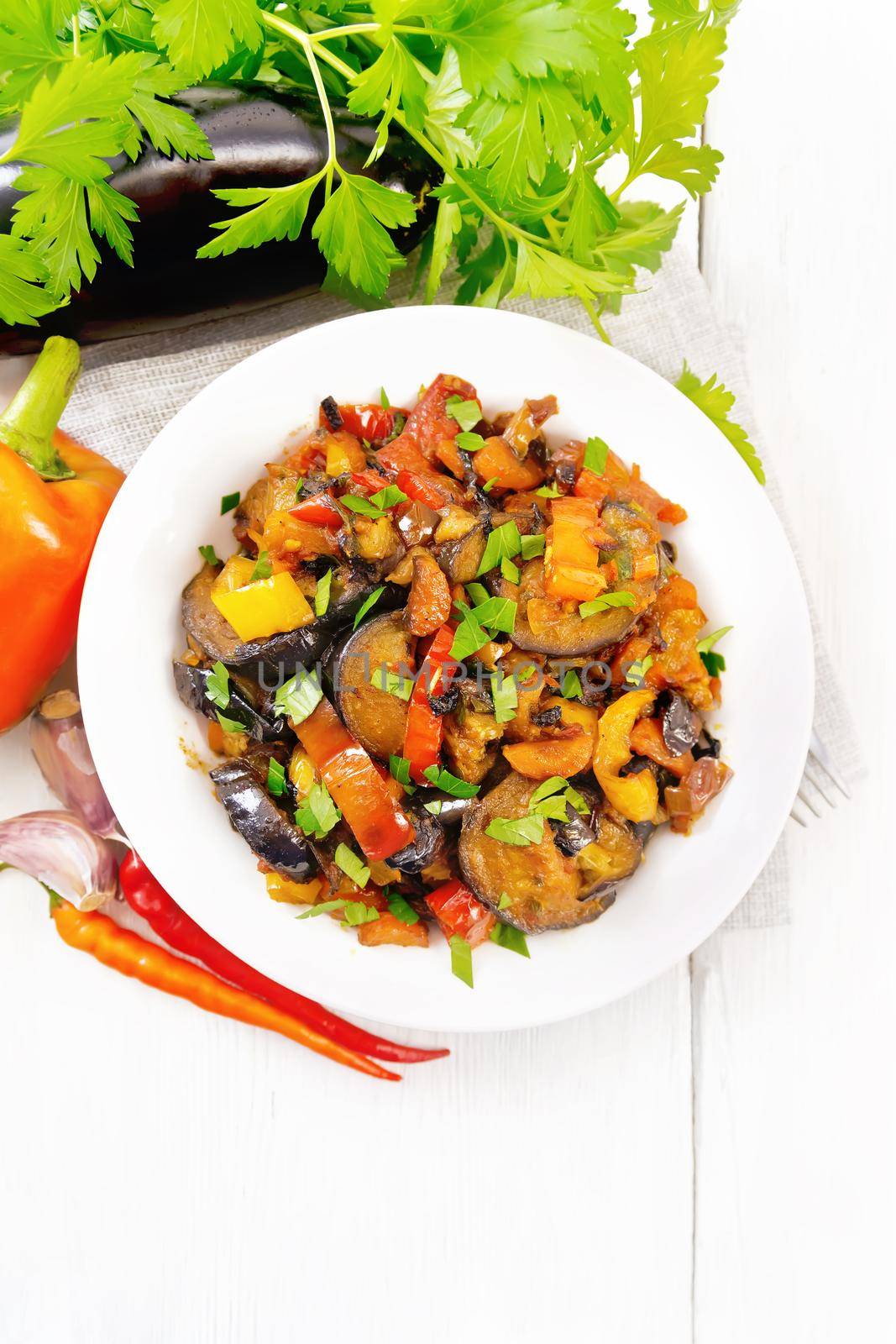 Ragout with eggplant and pepper on light board top by rezkrr