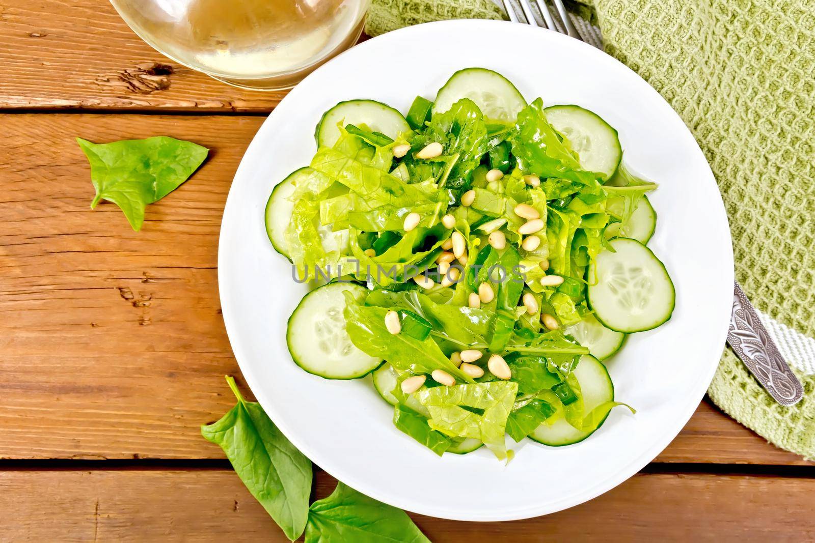 Salad from spinach and cucumber with lettuce on board top by rezkrr