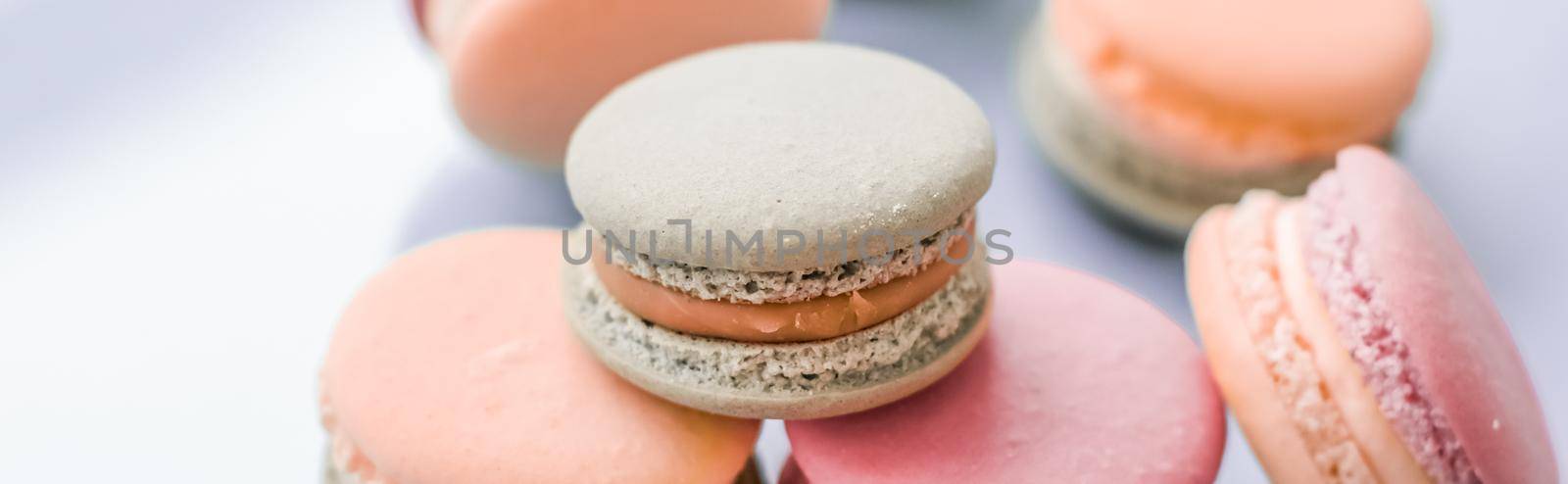 Pastry, bakery and branding concept - French macaroons on blue background, parisian chic cafe dessert, sweet food and cake macaron for luxury confectionery brand, holiday backdrop design