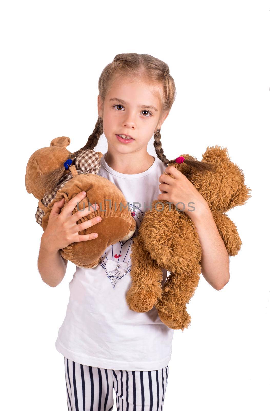 Little girl holding a teddy bear. Isolated on white background. Girl hugging two teddybears. Happy child.