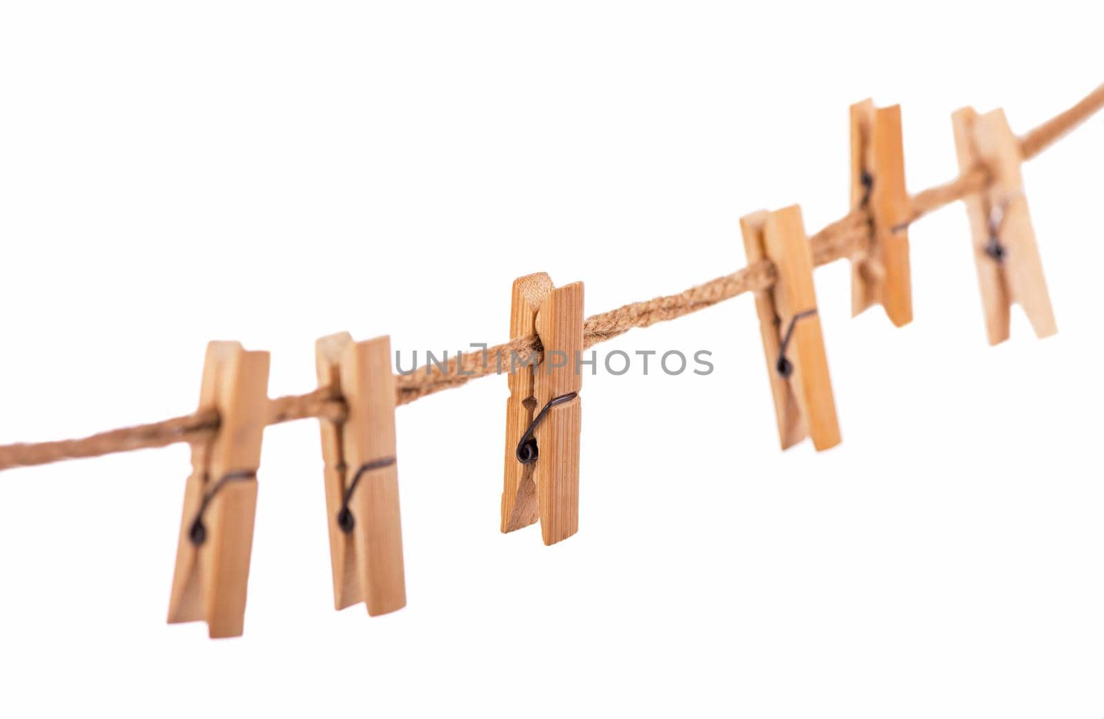 Wooden Clothespins with the rope on a white background
