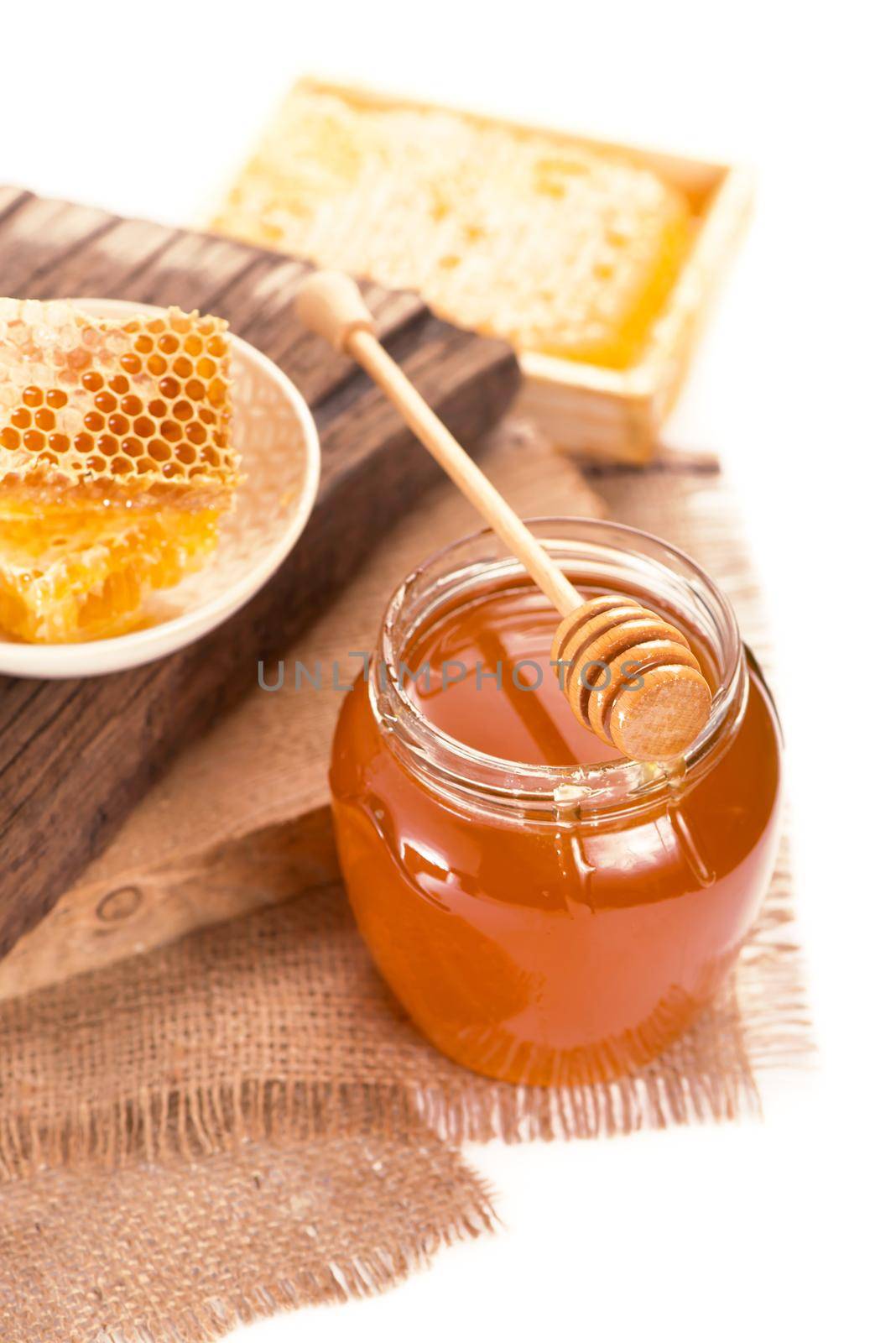 glass pot with floral honey isolated on white background by aprilphoto