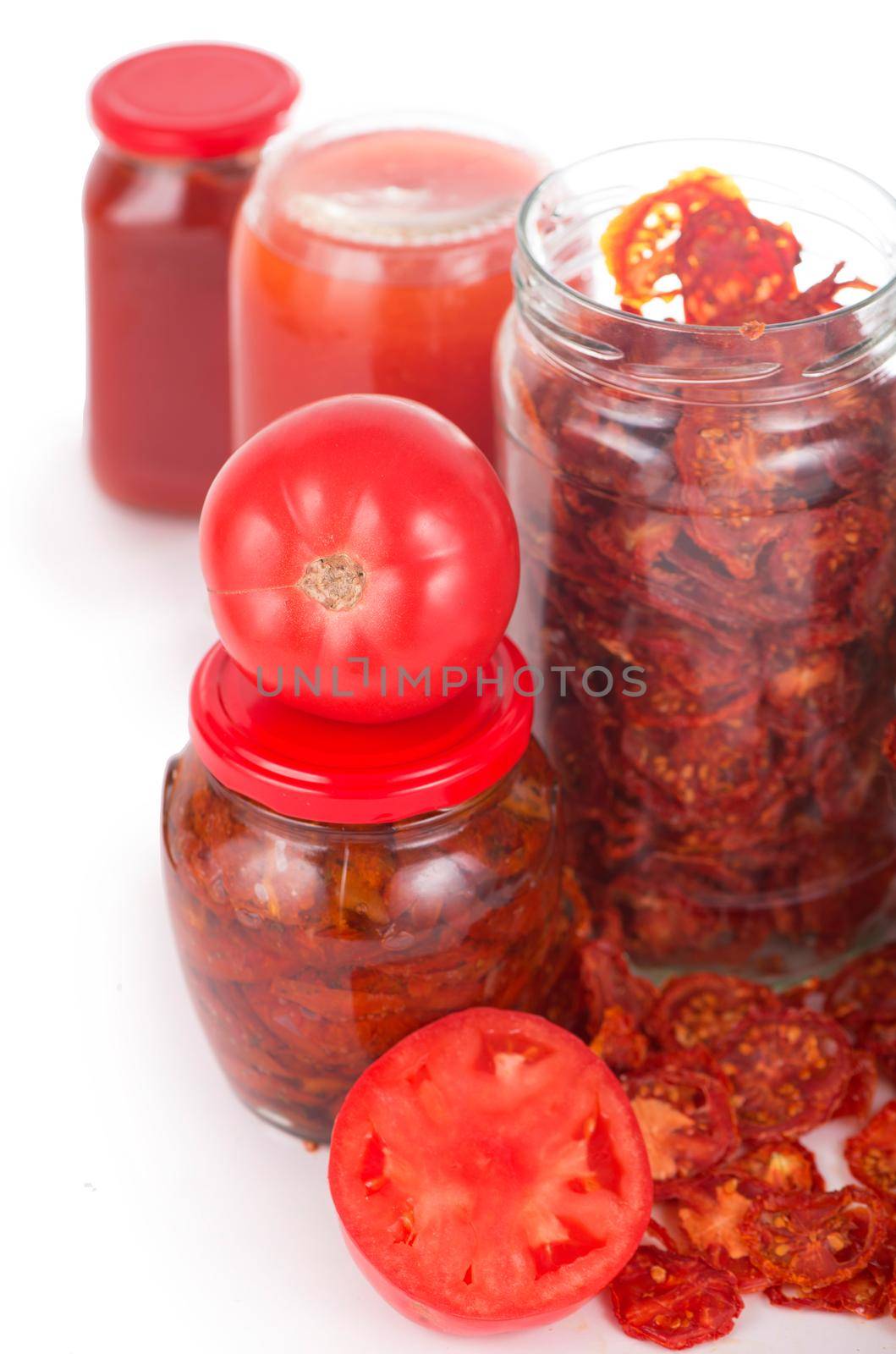Bowl of sun dried tomatoes on wooden background, top view