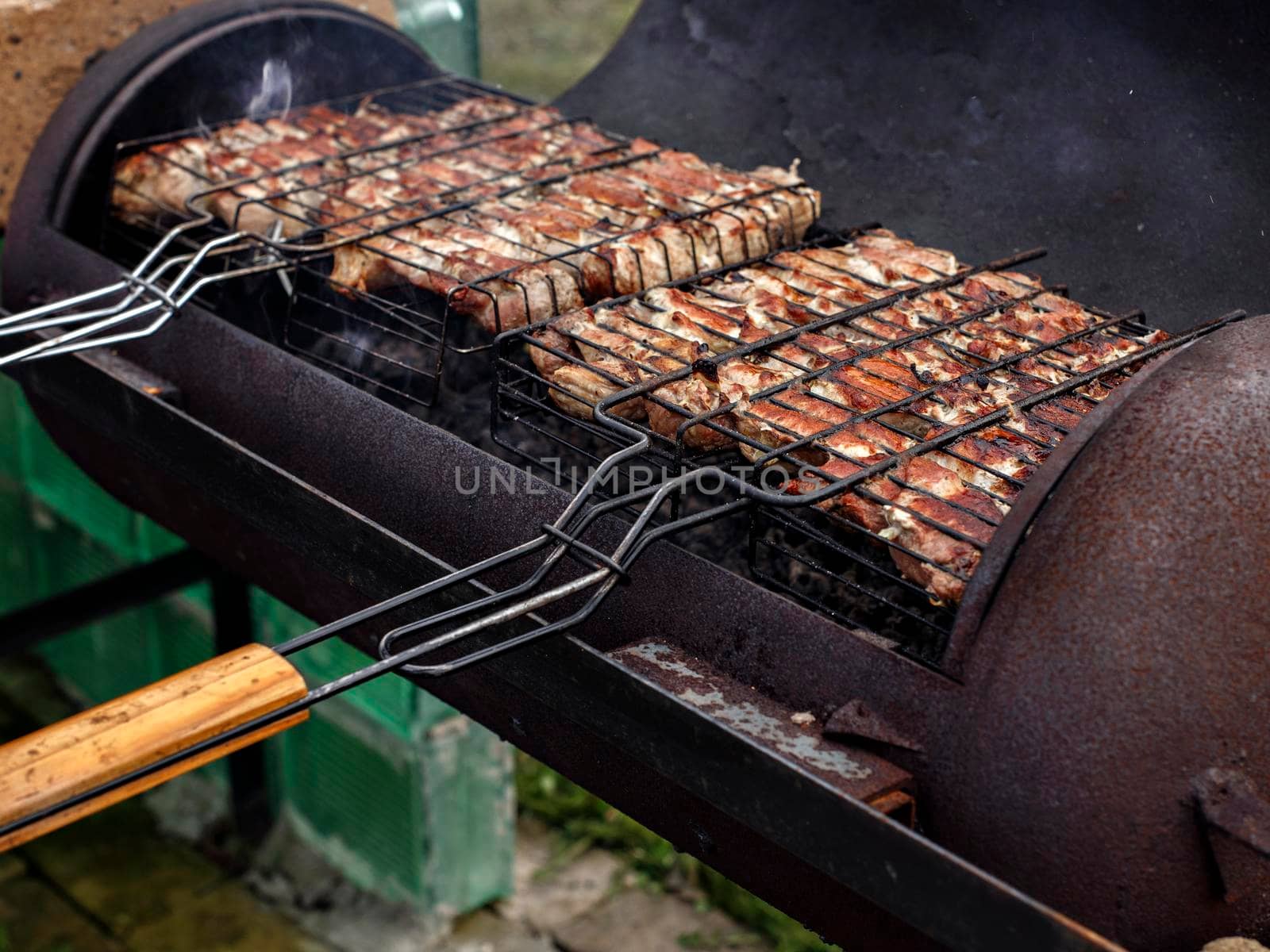 Meat for shish kebab is fried on grill.