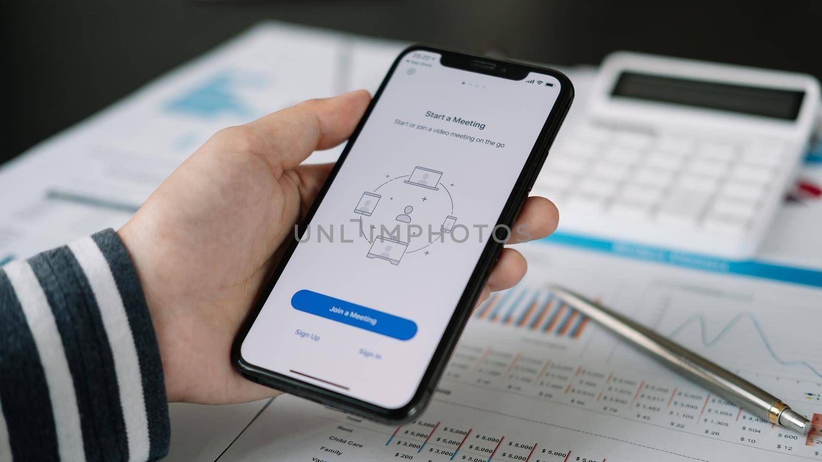 CHIANG MAI, THAILAND - APR 11, 2020 : A working from home employee is downloading the Zoom application social platform, ready for internet meetings, remote workers or online education by nateemee