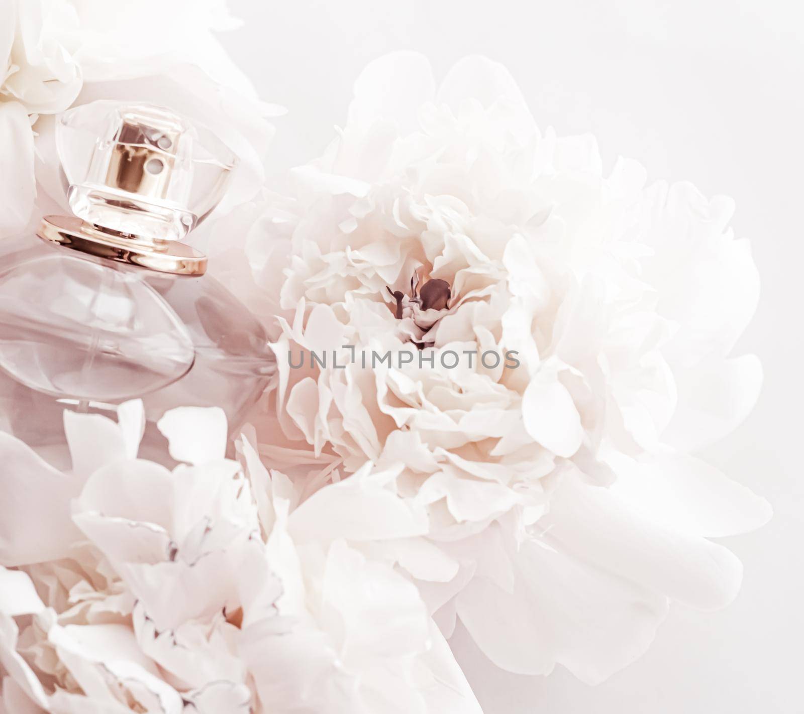 Fragrance bottle as luxury perfume product on background of peony flowers, parfum ad and beauty branding design