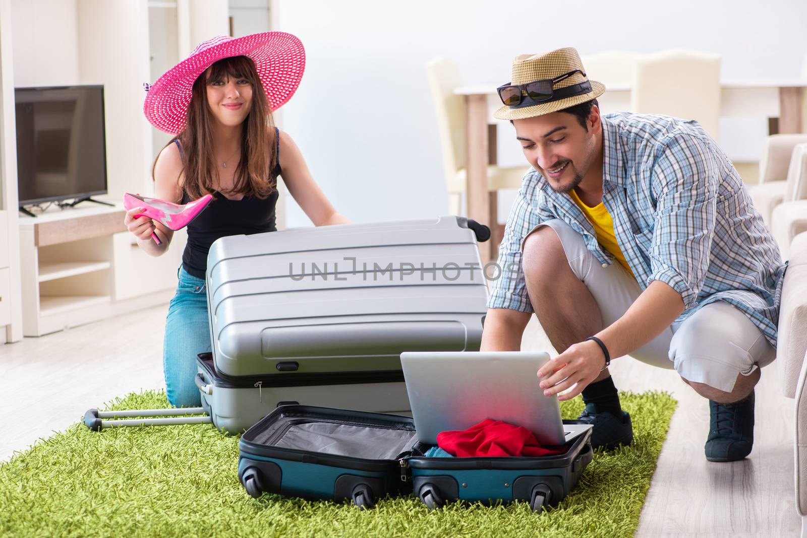 Young pair packing for summer vacation travel