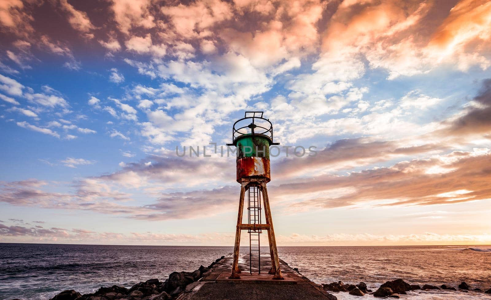 Jetty and lighthouse in Saint-Pierre, La Reunion island by photogolfer