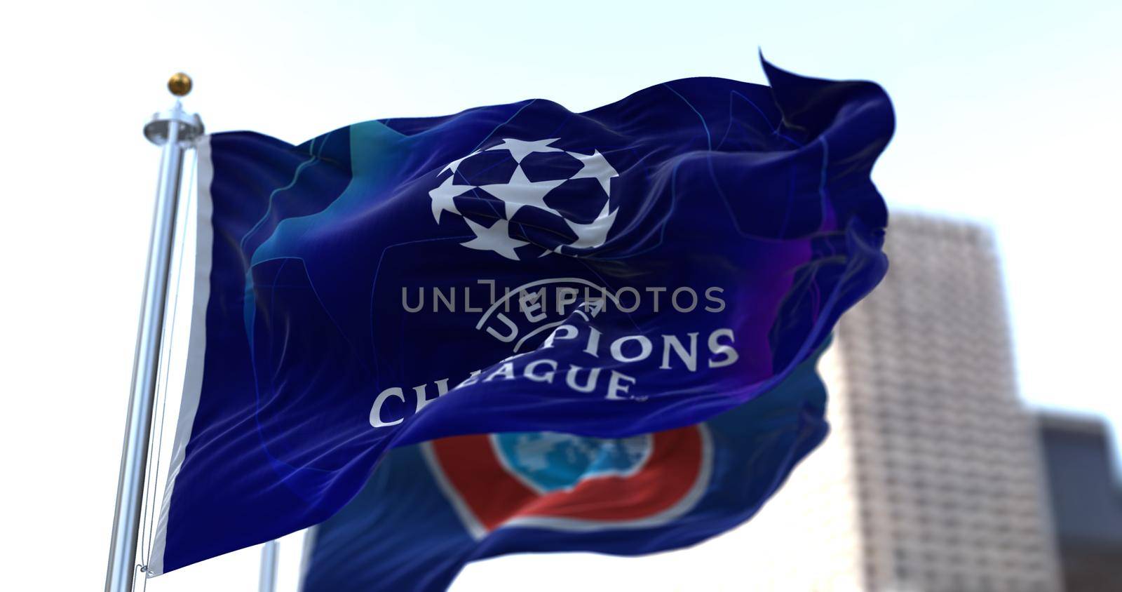 Nyon, SWI, May 2021: The flag of Champions League flapping in the wind with the UEFA flag blurred in the background. Champions League is the most important football tournament between European teams