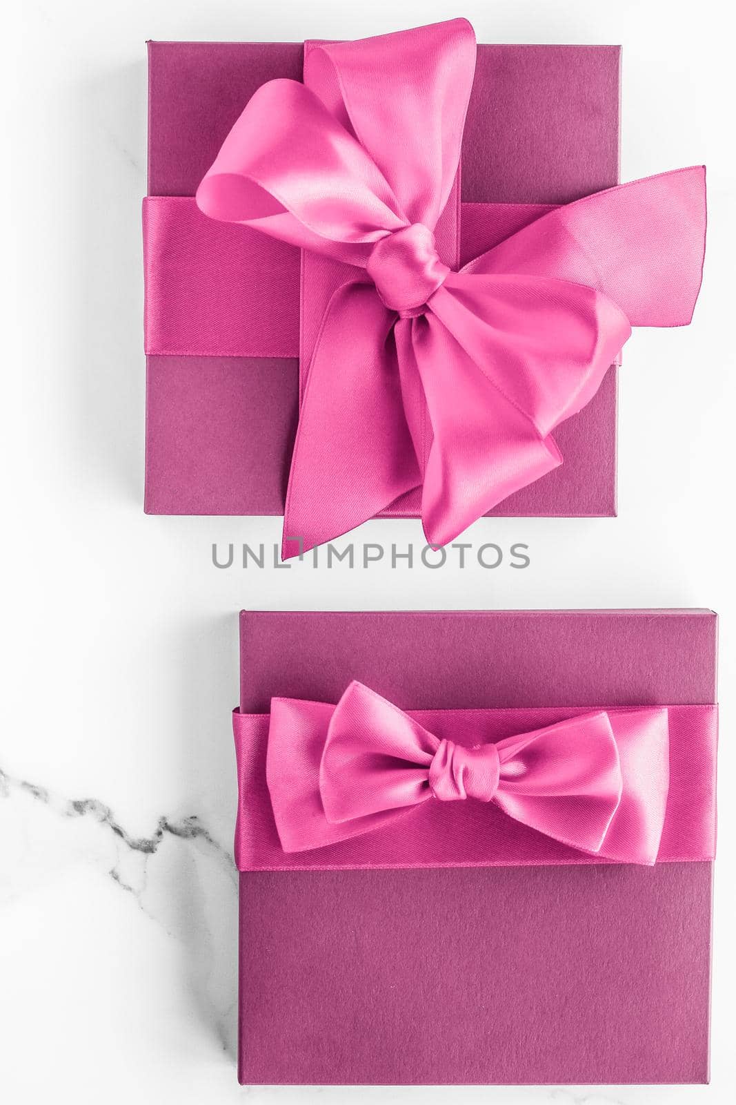 Birthday, wedding and girly branding concept - Pink gift box with silk bow on marble background, girl baby shower present and glamour fashion gift for luxury beauty brand, holiday flatlay art design