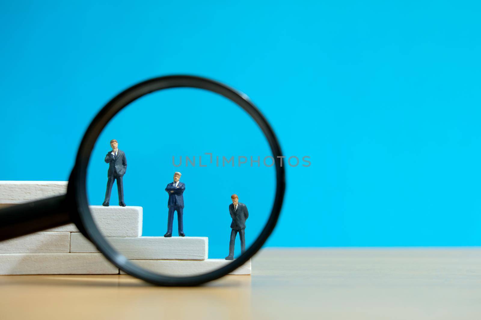 Business strategy conceptual photo - Miniature of businessman stands on a podium. Image photo