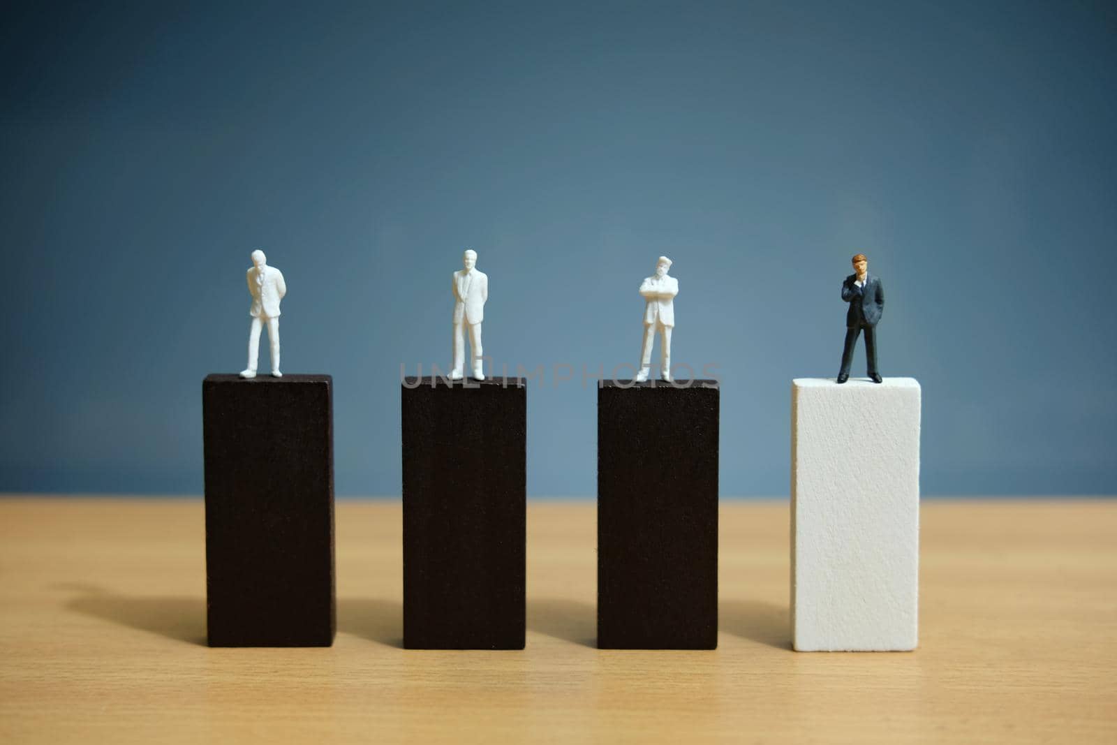 Business strategy conceptual photo – miniature of businessman stands on wooden wall. Image photo