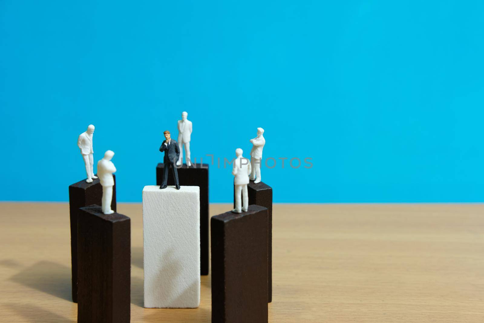Business conceptual photo – group miniature of businessman have group discussion above wooden puzzle block. Image photo