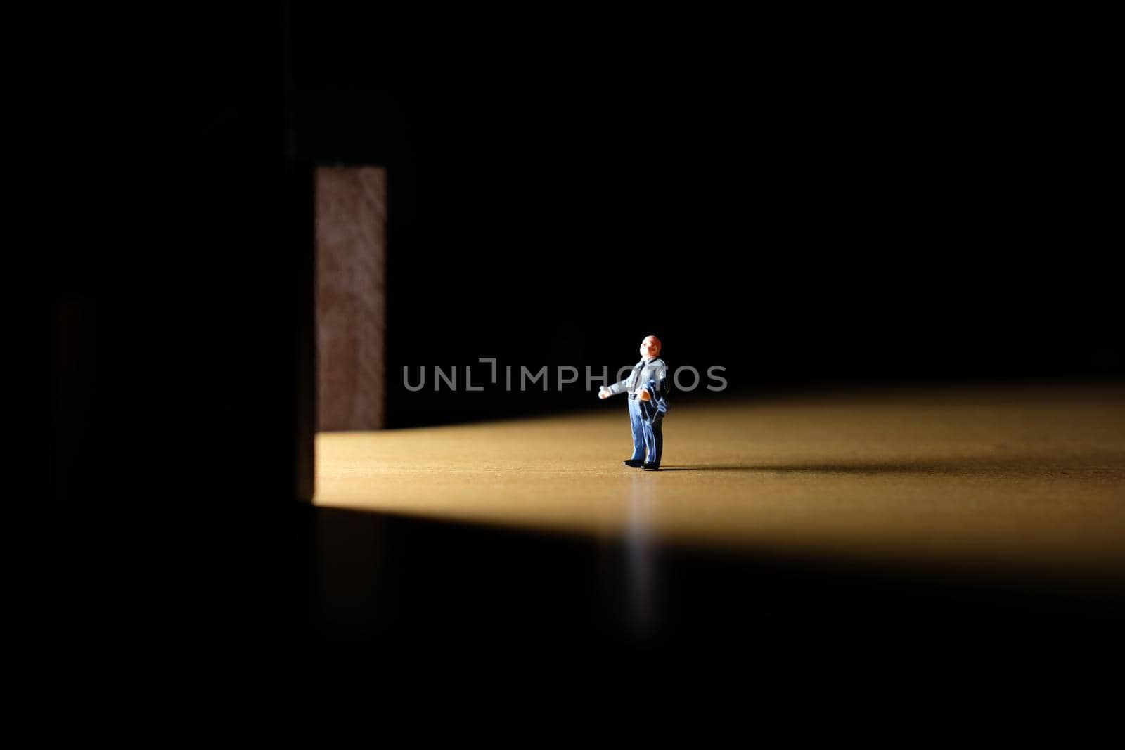 Business conceptual photo – miniature of businessman entering office building by Macrostud