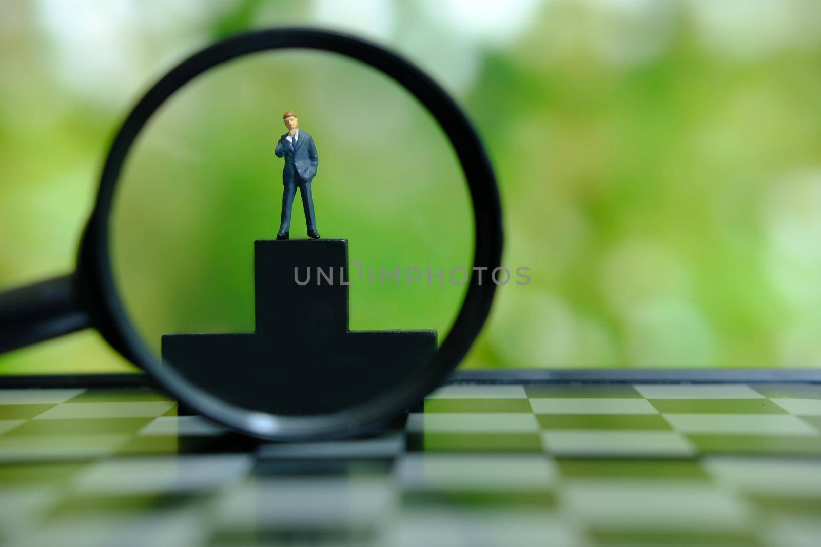 Business conceptual photo – miniature of businessman stands on wooden podium. Image photo