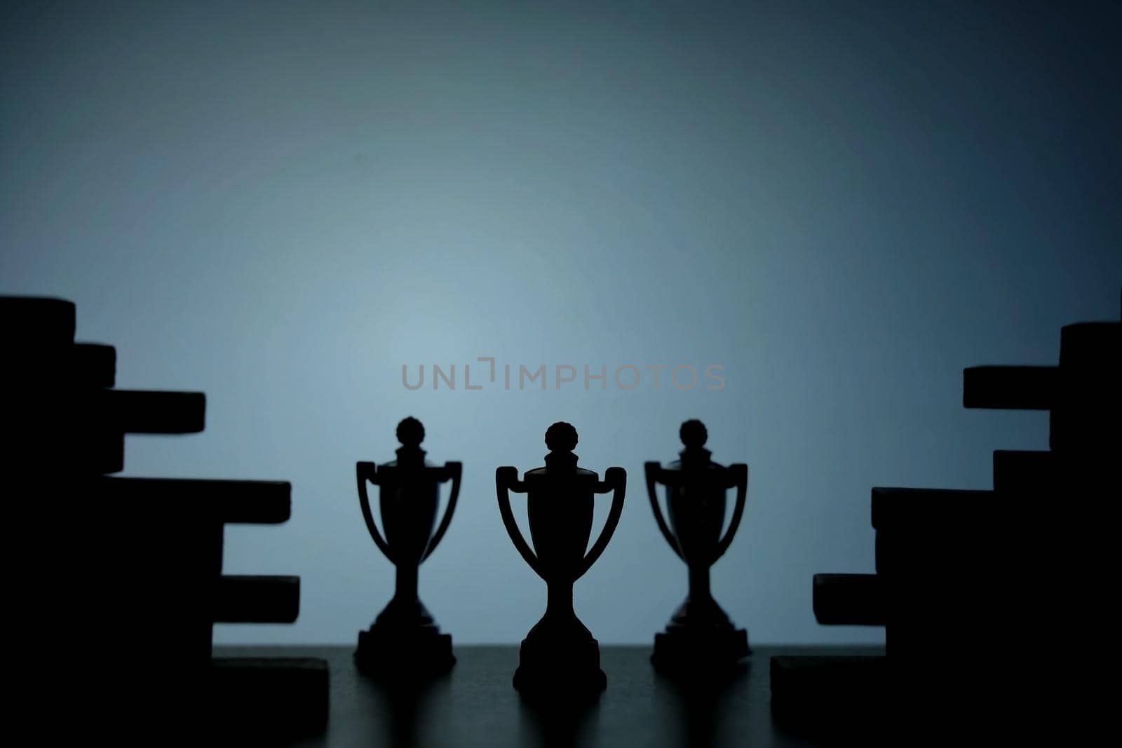 Business strategy conceptual photo – Silhouette of trophy stand in the middle of jigsaw puzzle by Macrostud