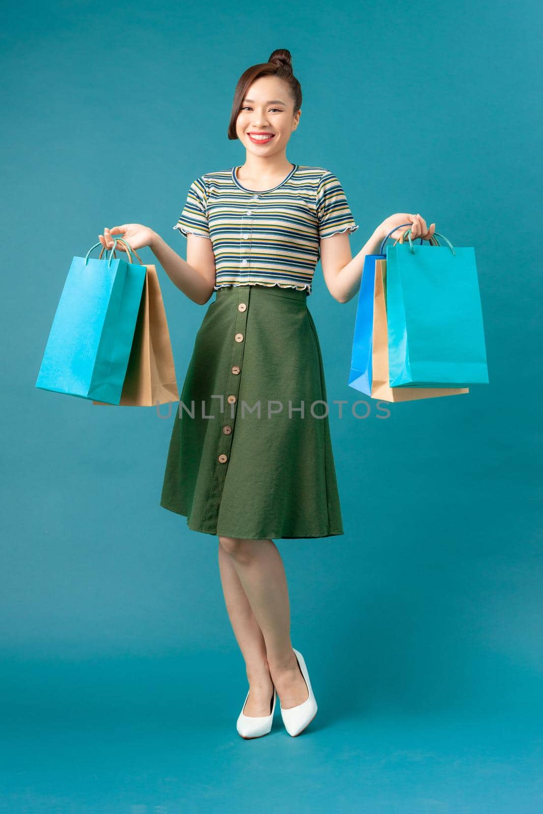 woman take shopping bag happily on blue background