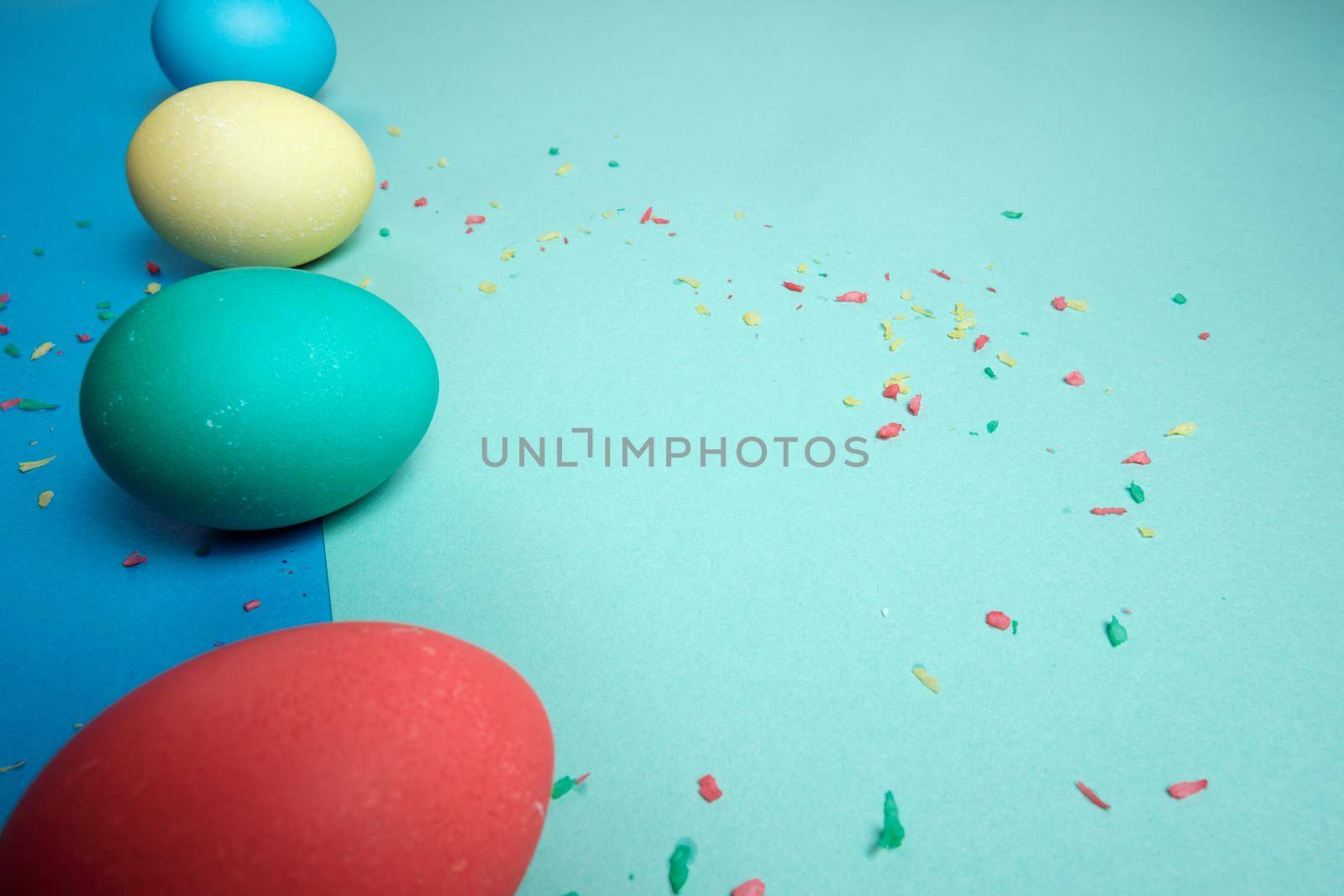 Colored chicken eggs. Easter holiday. Abstraction. Place for text.