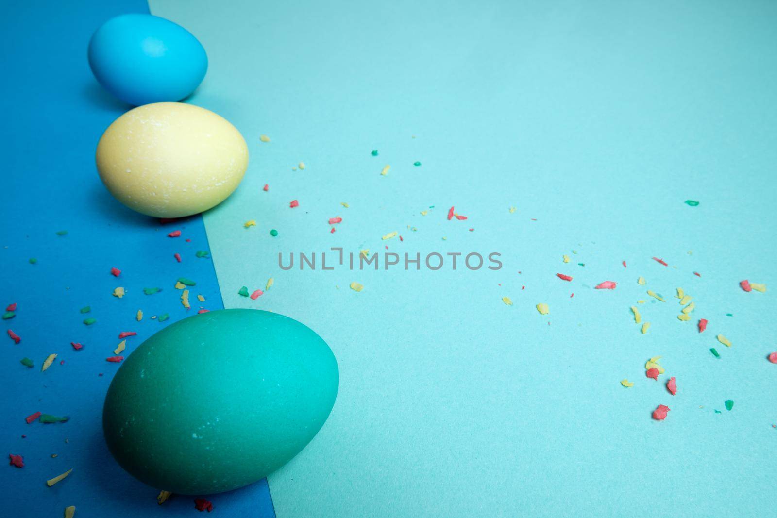 Colored chicken eggs. Easter holiday. Abstraction. Place for text.