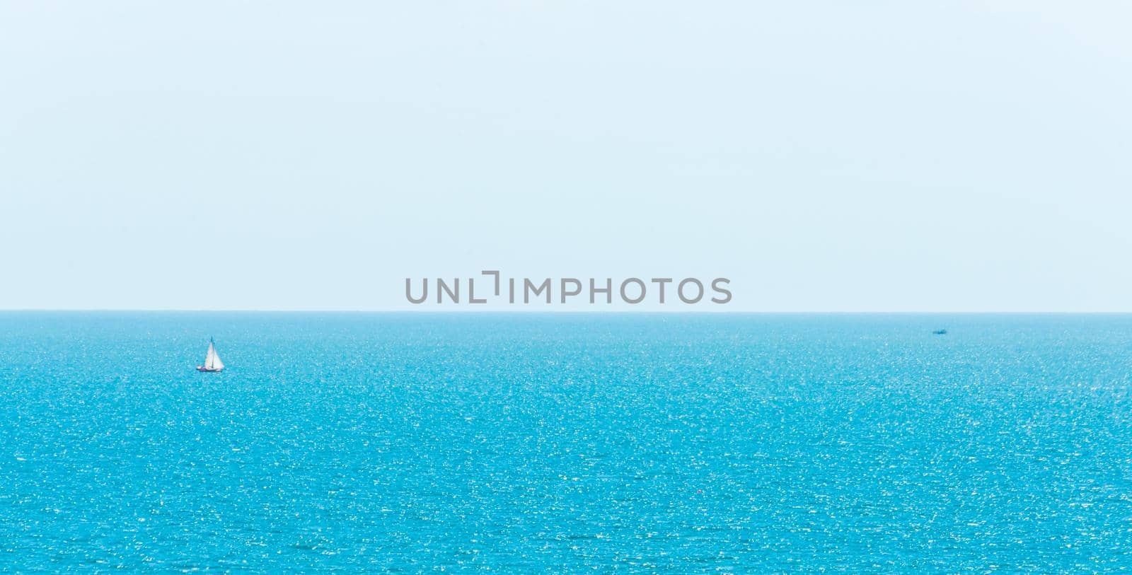 Ocean infinity, yacht sailing the ocean, clear sky, blue water, recreational sport