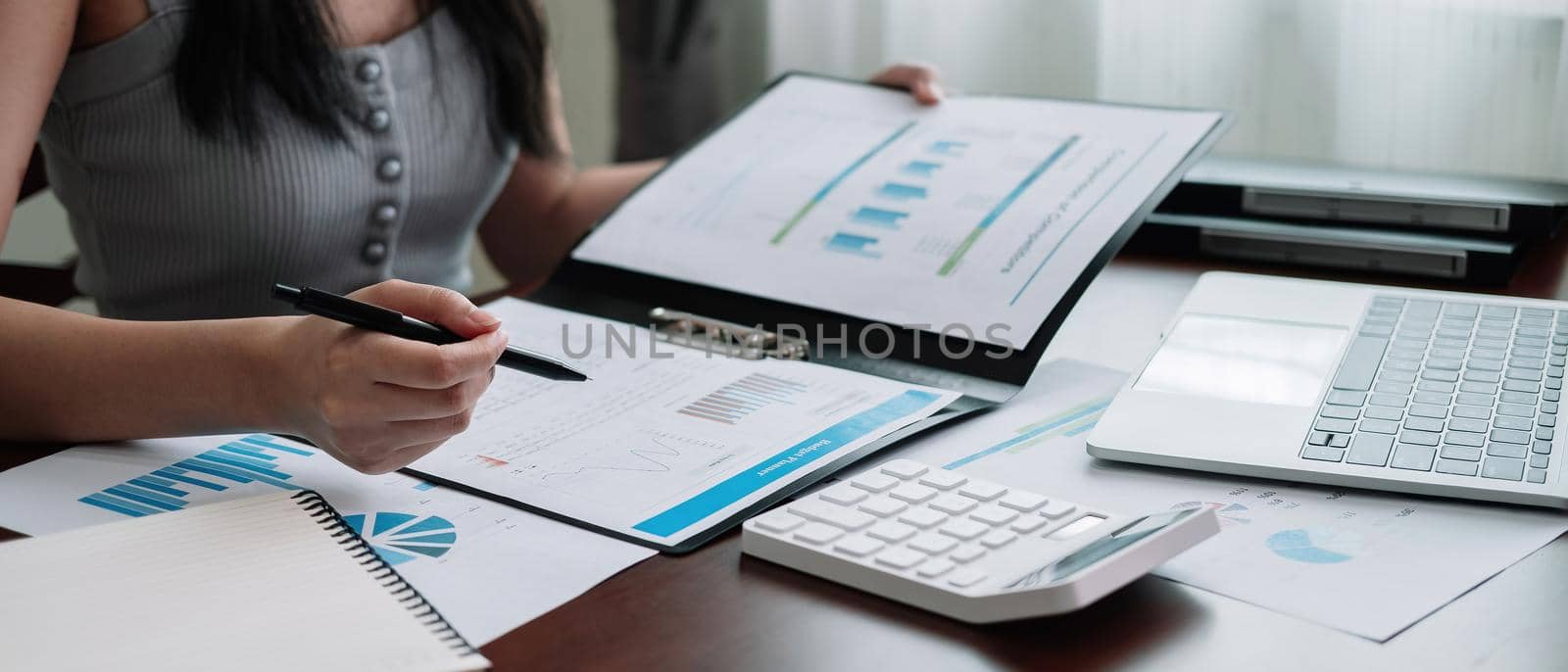 Working from home, Corona virus protection, Closeup business woman using laptop computer and analyzing financial report, Woman in quarantine. by nateemee