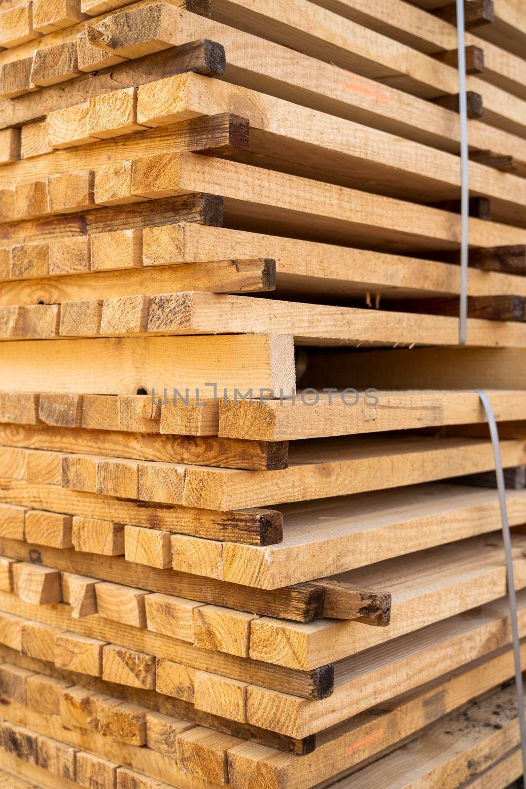 Storage of piles of wooden boards on the sawmill. Boards are stacked in a carpentry shop. Sawing drying and marketing of wood. Pine lumber for furniture production, construction. Lumber Industry. by vovsht