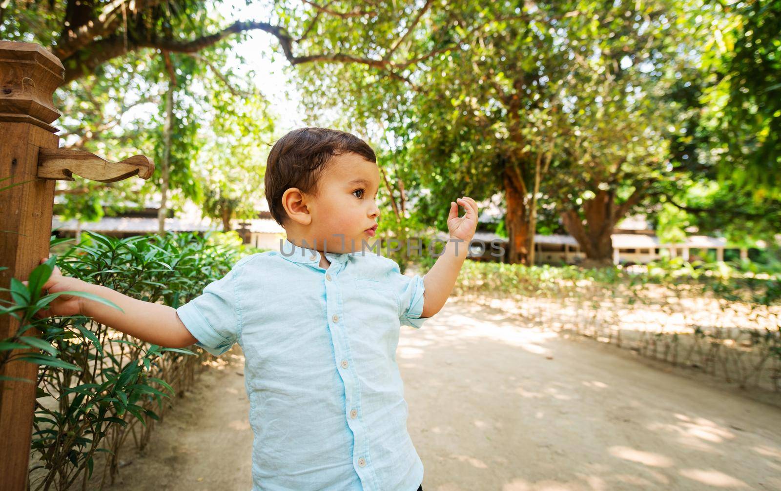 Toddler in beautiful park by dutourdumonde