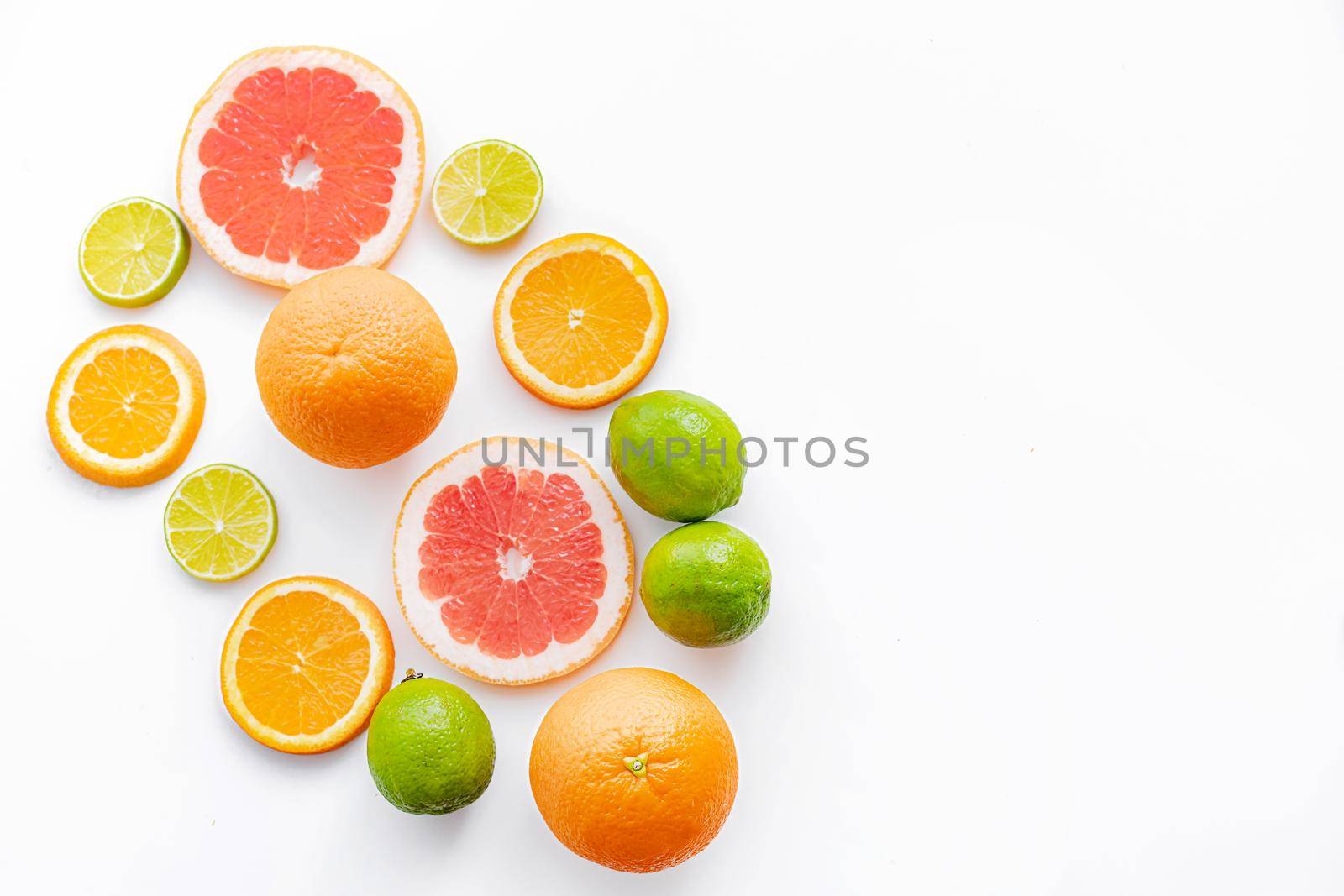 Citrus fruits on a white background are cut . Colored fruits. The citrus family. citrus sliced layout top view on a white background. An article about healthy eating. Keto diet. Fruit food.
