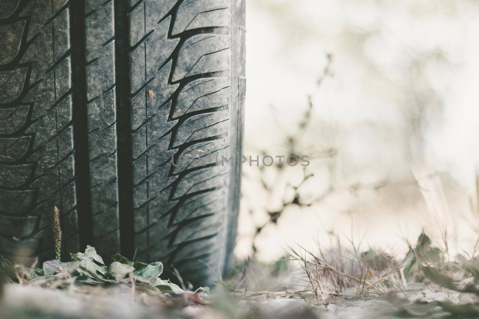 Car tire and sandy ground with text space, desert