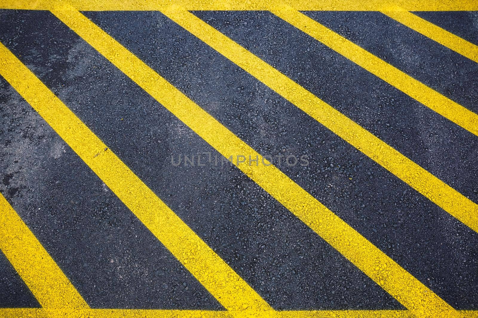 Yellow lines on black asphalt road. Background with copy space