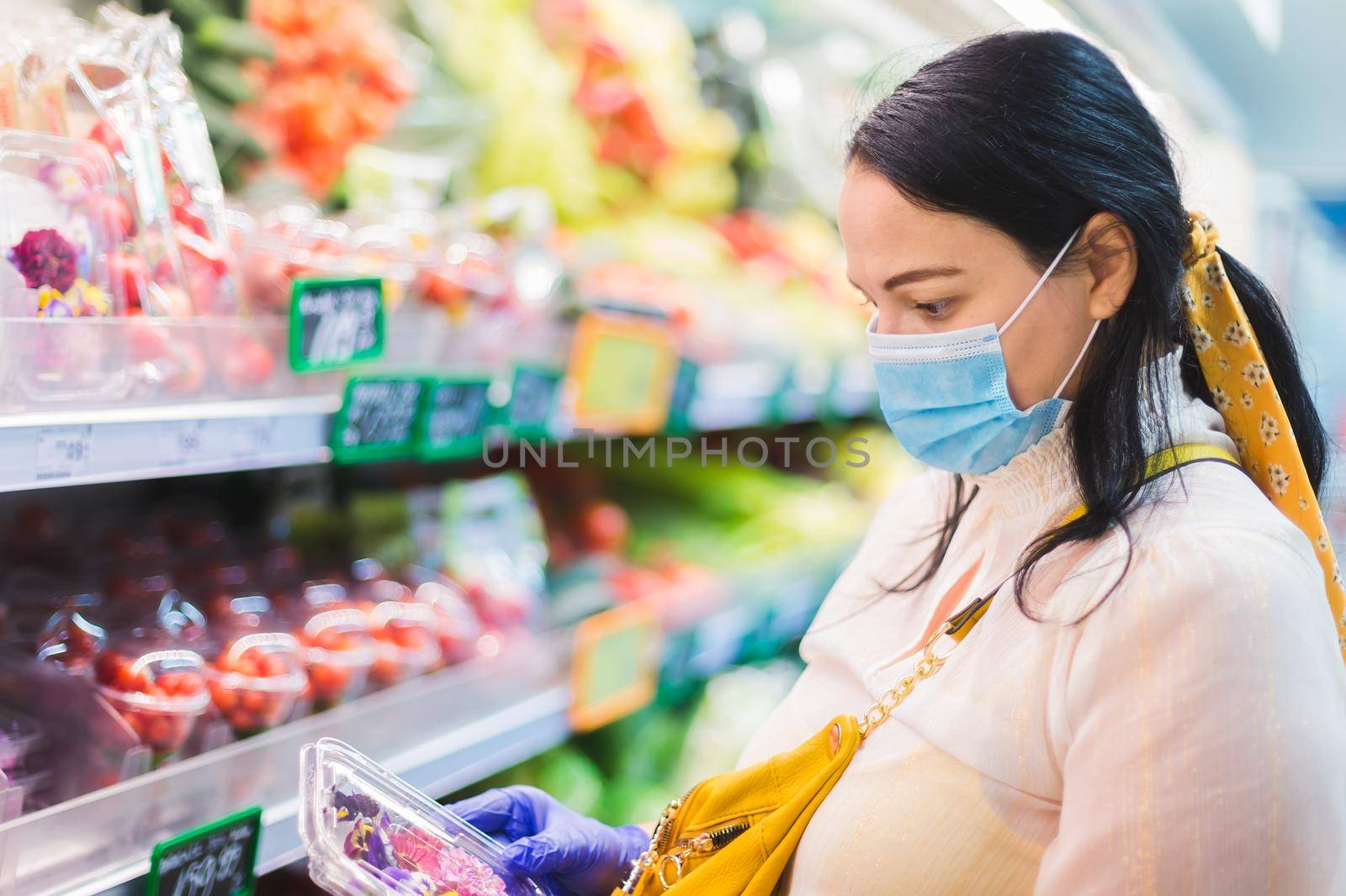 woman buying in the supermarket during the pandemic of Covid-19. Selective focus