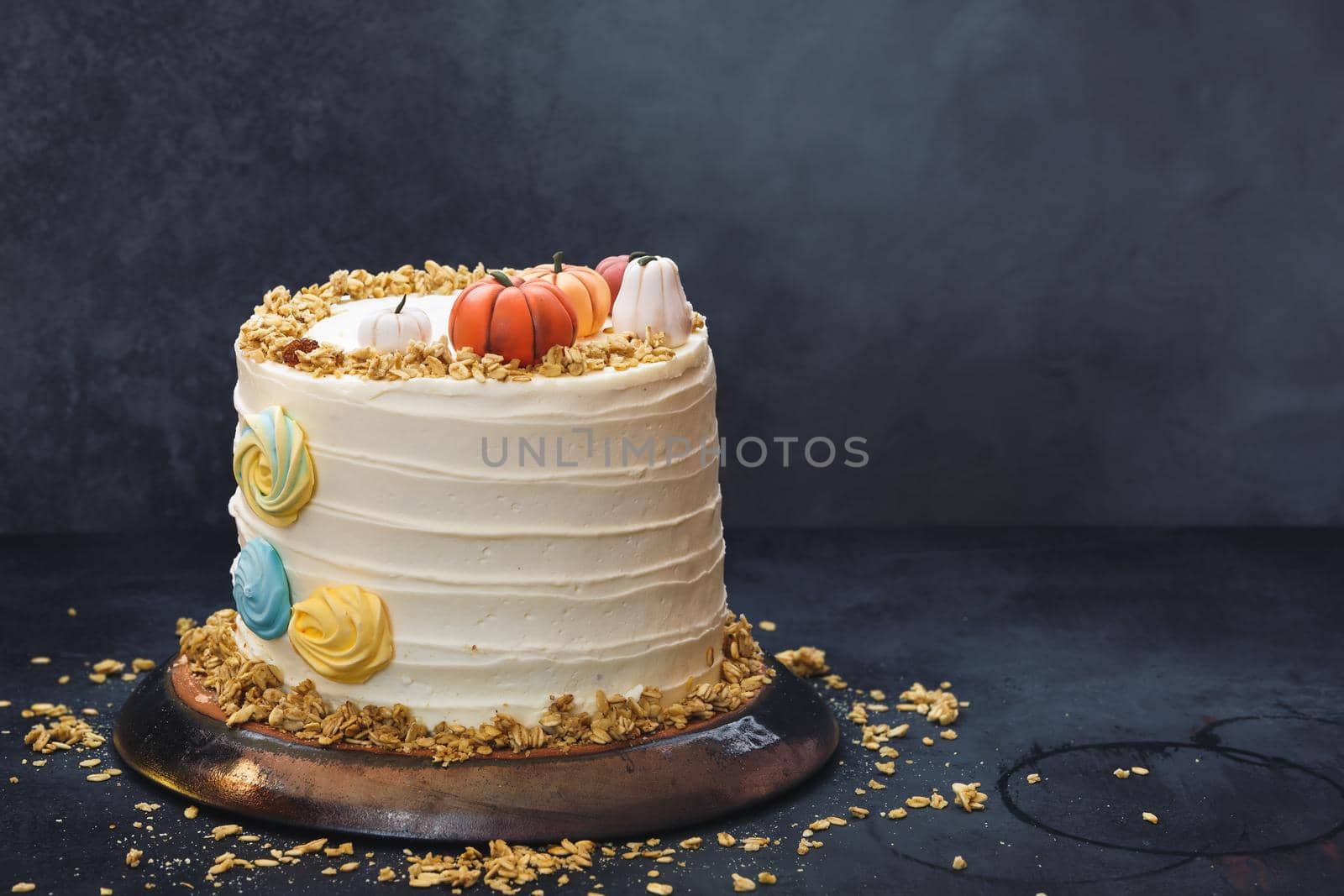 Pumpkin Spice Cake with Cream Cheese Frosting on Rustic Wooden Table With Autumnal Decoration. Selective focus, copy space by Slast20