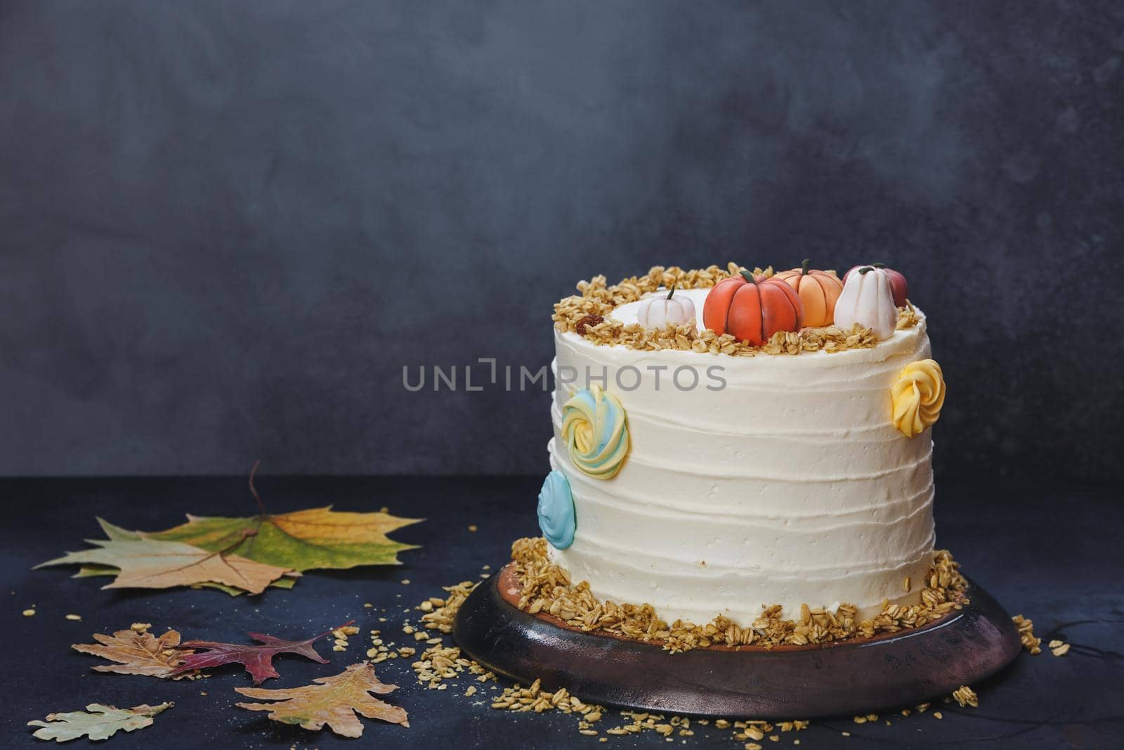Pumpkin Spice Cake with Cream Cheese Frosting on Rustic Wooden Table With Autumnal Decoration.  Selective focus, copy space by Slast20