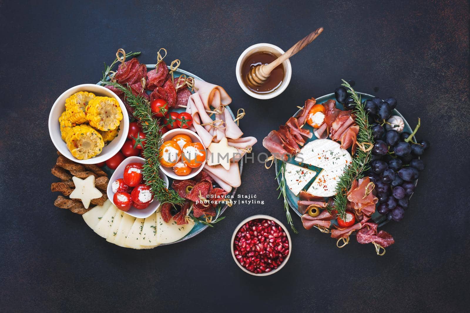 Plate of mixed tapas. Appetizer platter with cheese, salami, nuts olives , fruit, vegetable  and bread sticks.  Top view, blank space by Slast20