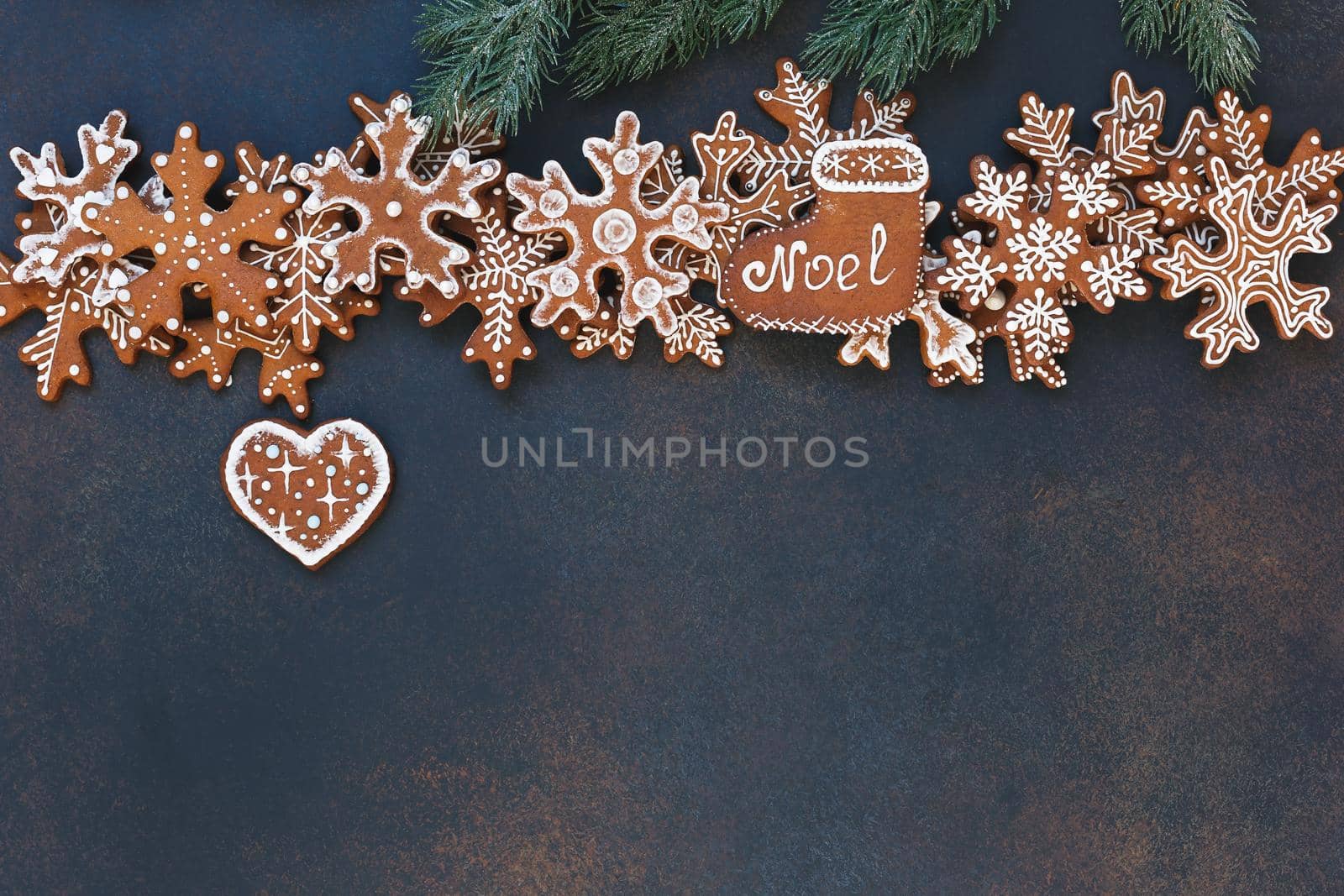 Christmas gingerbread snowflakes  and heart shaped cookies with decoration on rustic dark background. Christmas and New Year tradition concept by Slast20