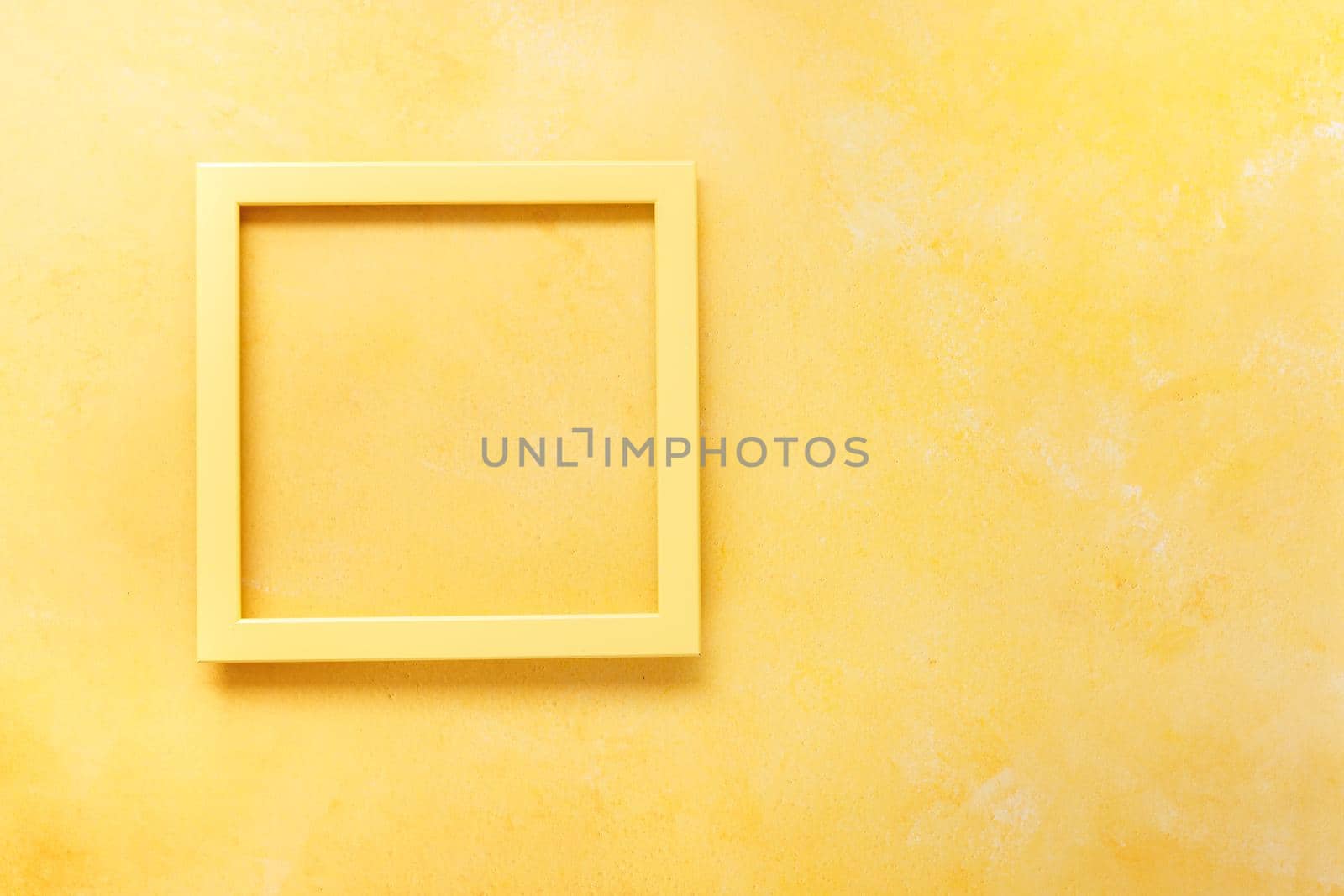 Yellow empty  frame on  rustic yellow surface. Top view, blank space by Slast20