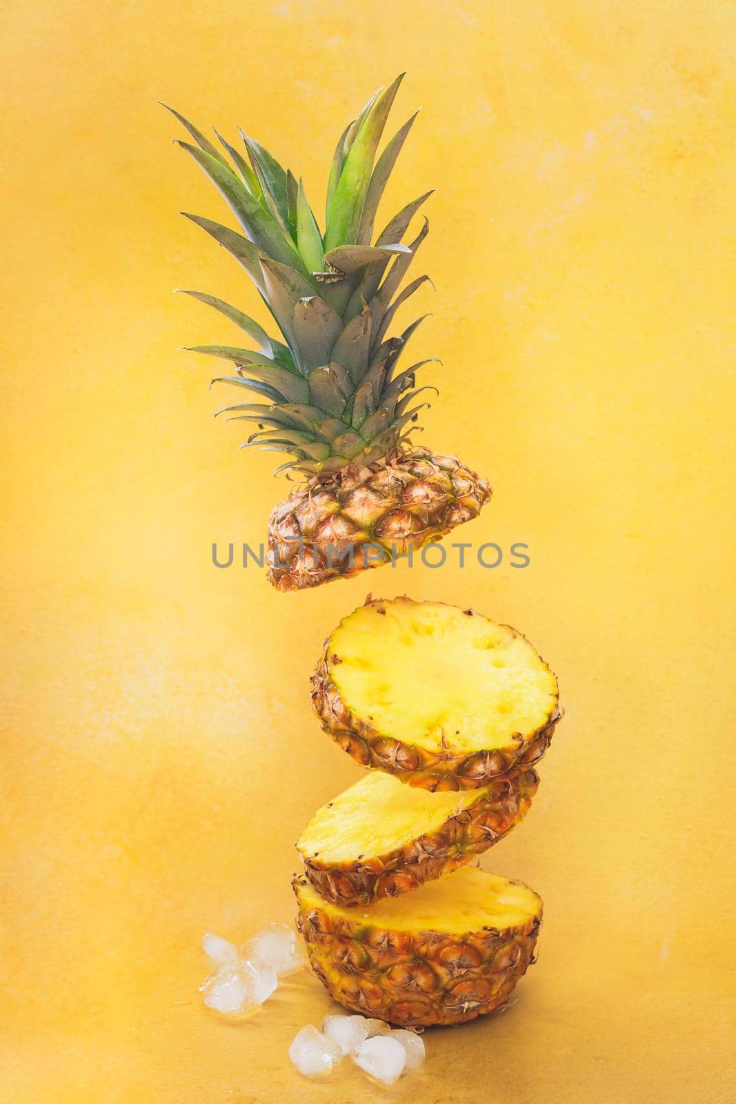 Flying  fresh ripe pineapple slices isolated on yellow background. Selective focus, copy space by Slast20