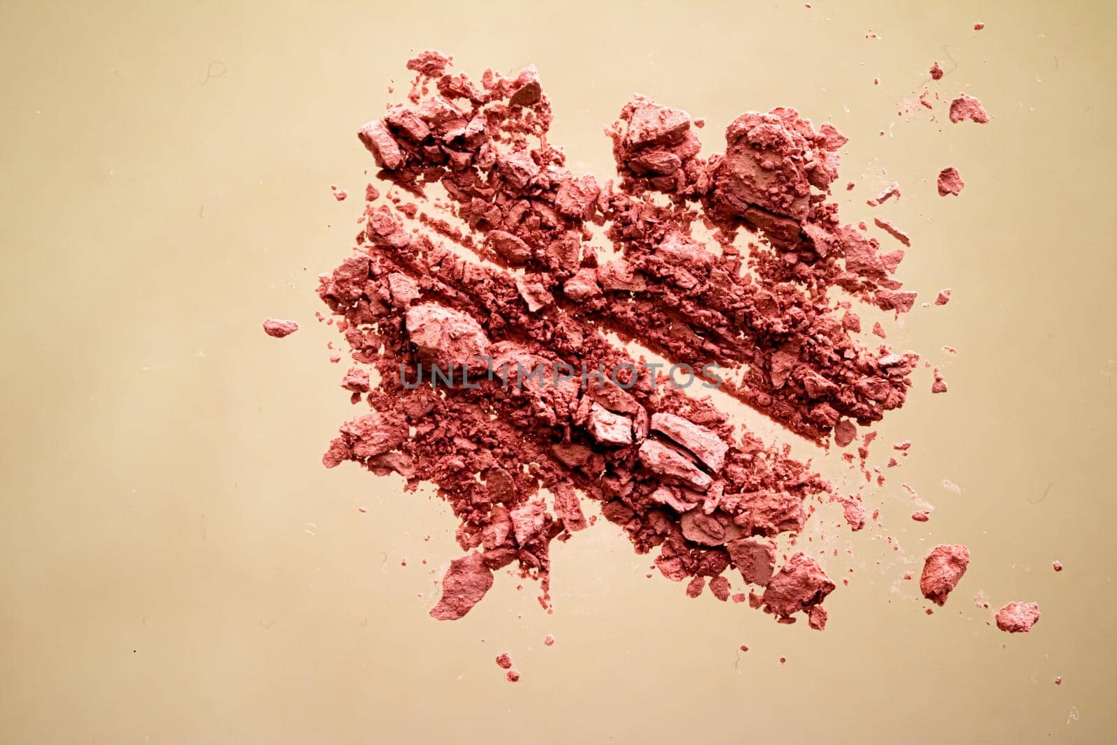 Crushed cosmetics, mineral organic eyeshadow, blush and cosmetic powder isolated on golden background, makeup and beauty banner, flatlay design.