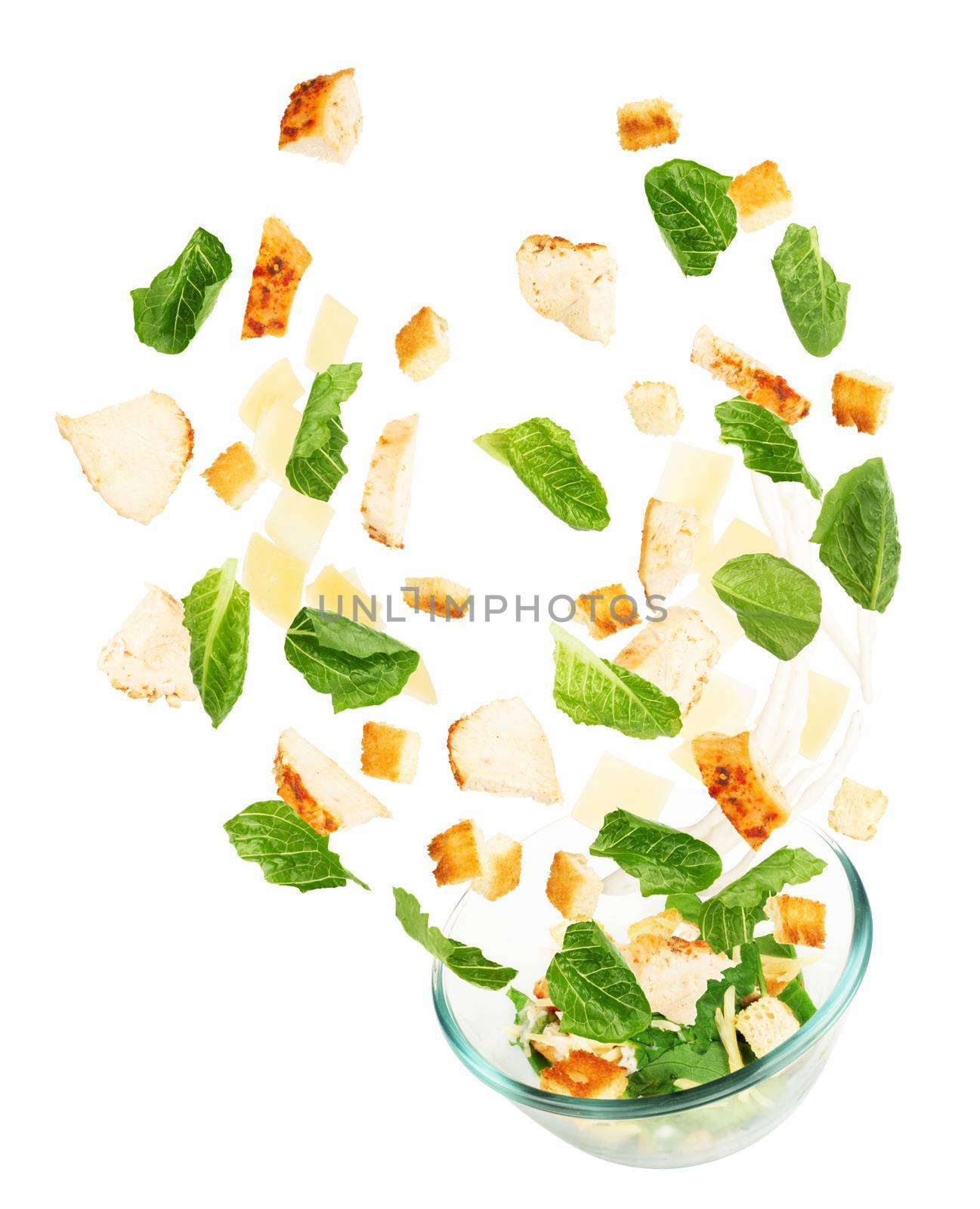 Glass salad bowl in flight with vegetables isolated on white background